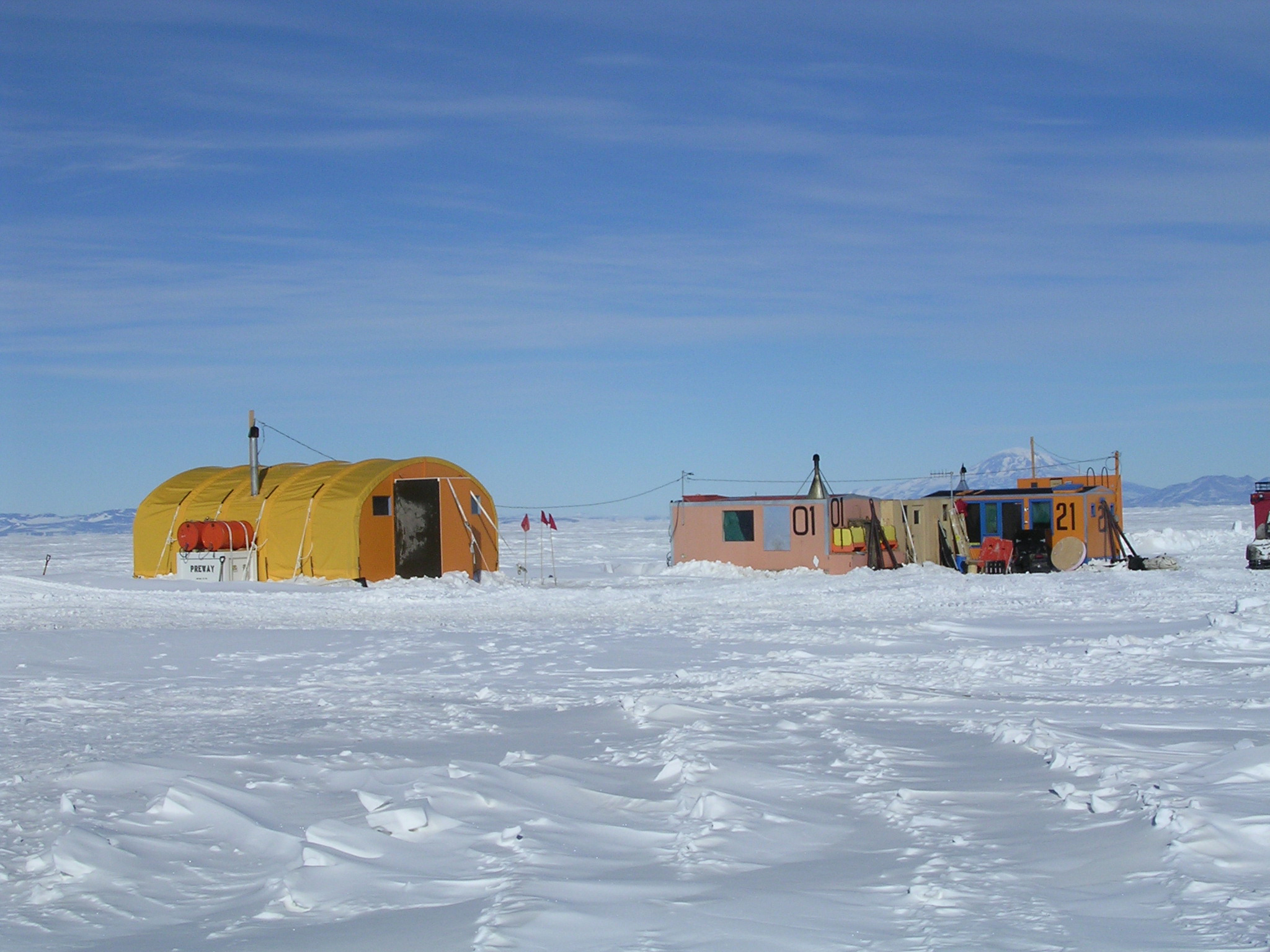 Colorful small buildings sit on snow.