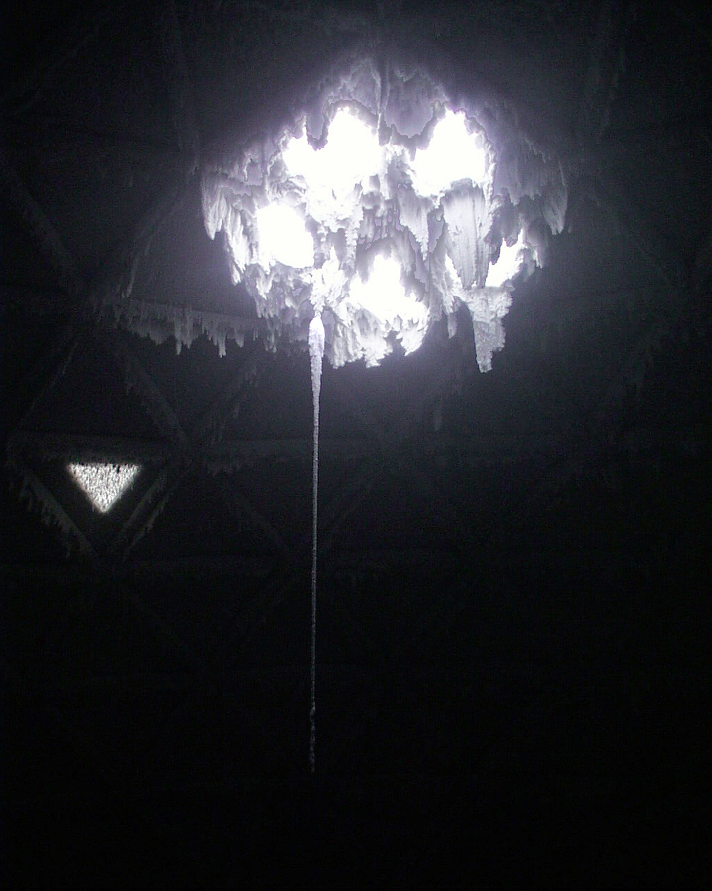 Icicles hang down from four holes in a ceiling.