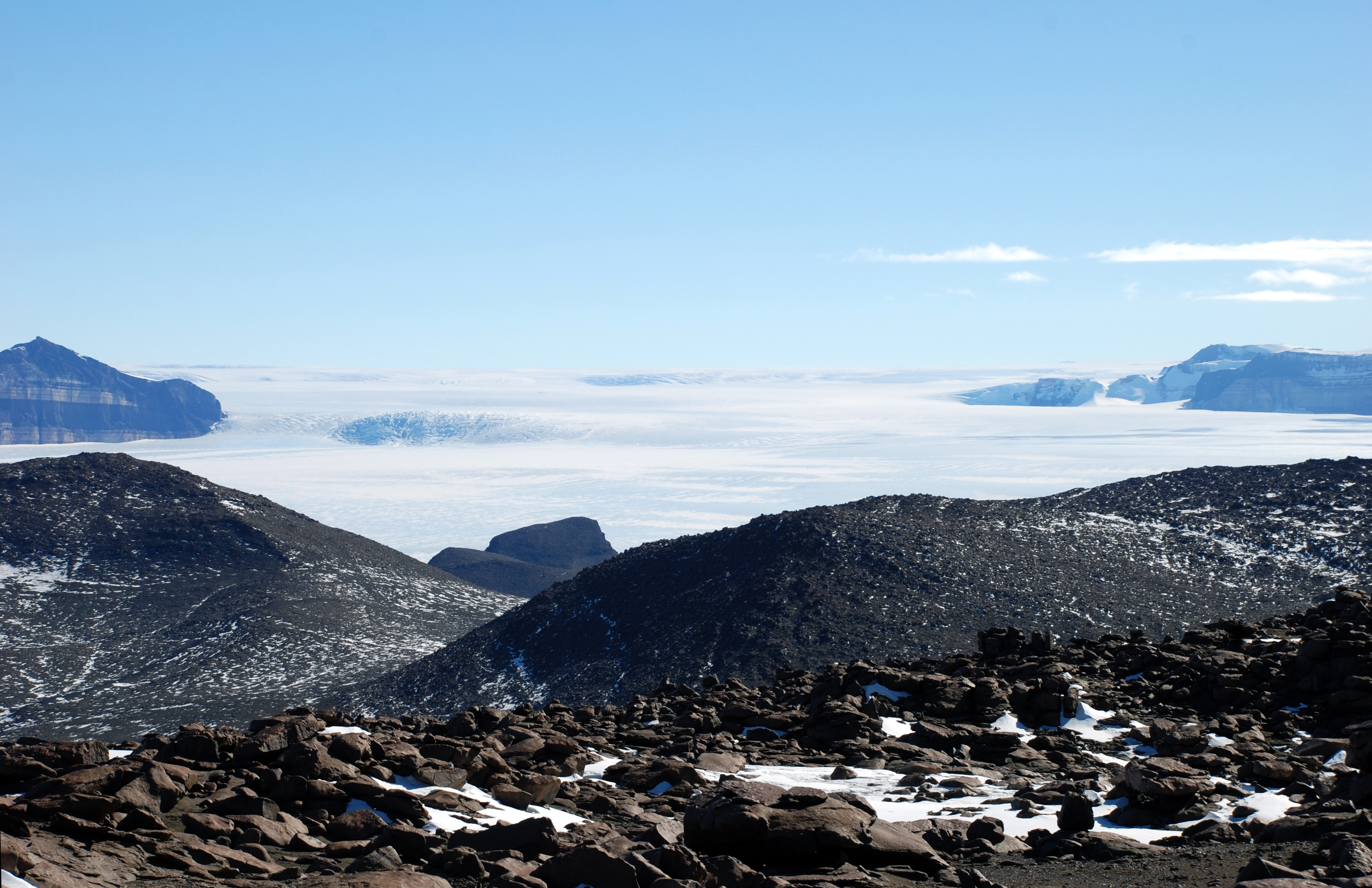 A glacier amidst mountains.