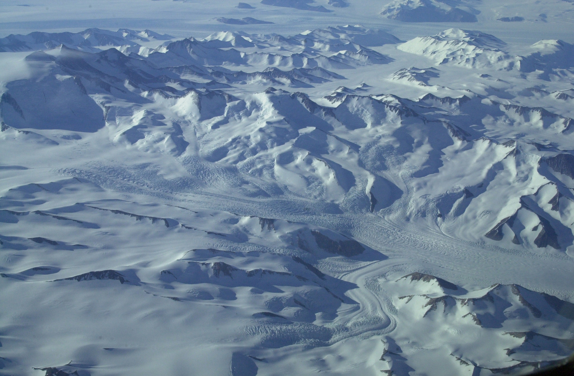 Aerial of snow and glacier covered mountains.