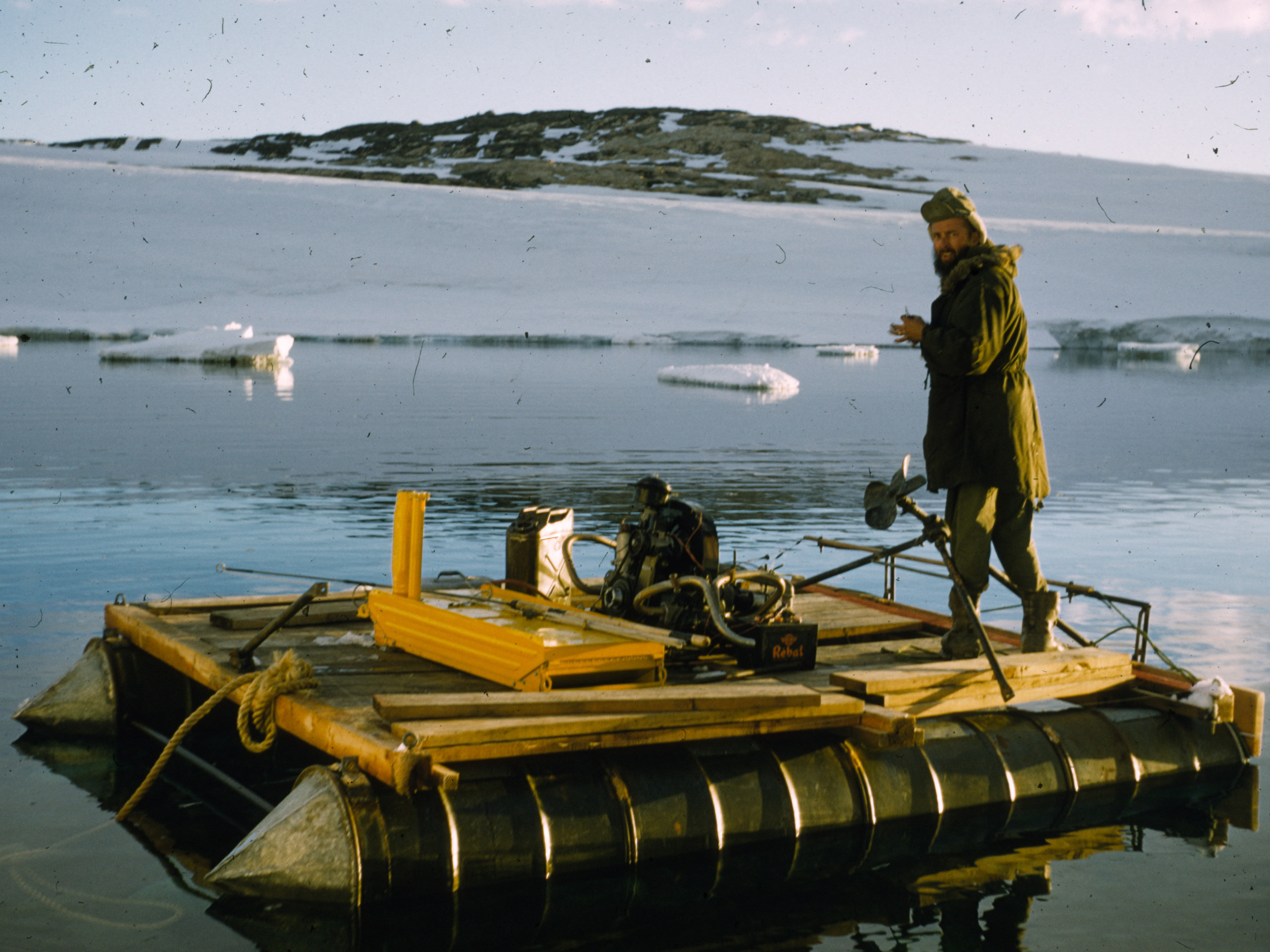 A man stands on a raft.