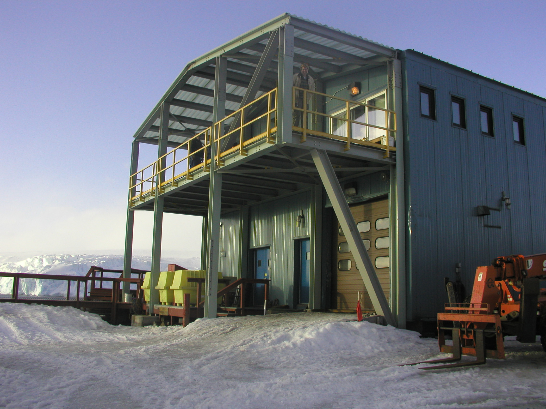 View of a blue building with a glacier behind