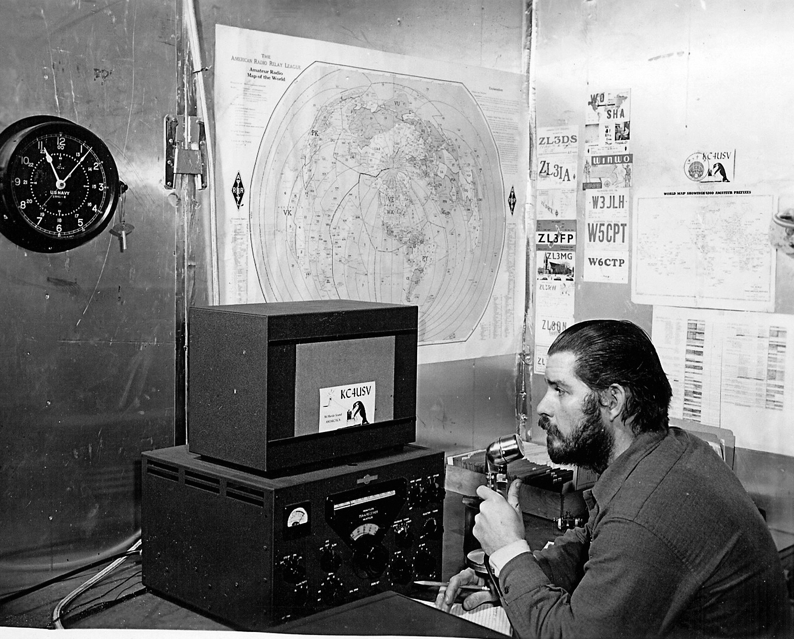 A man with a radio speaks into a microphone.