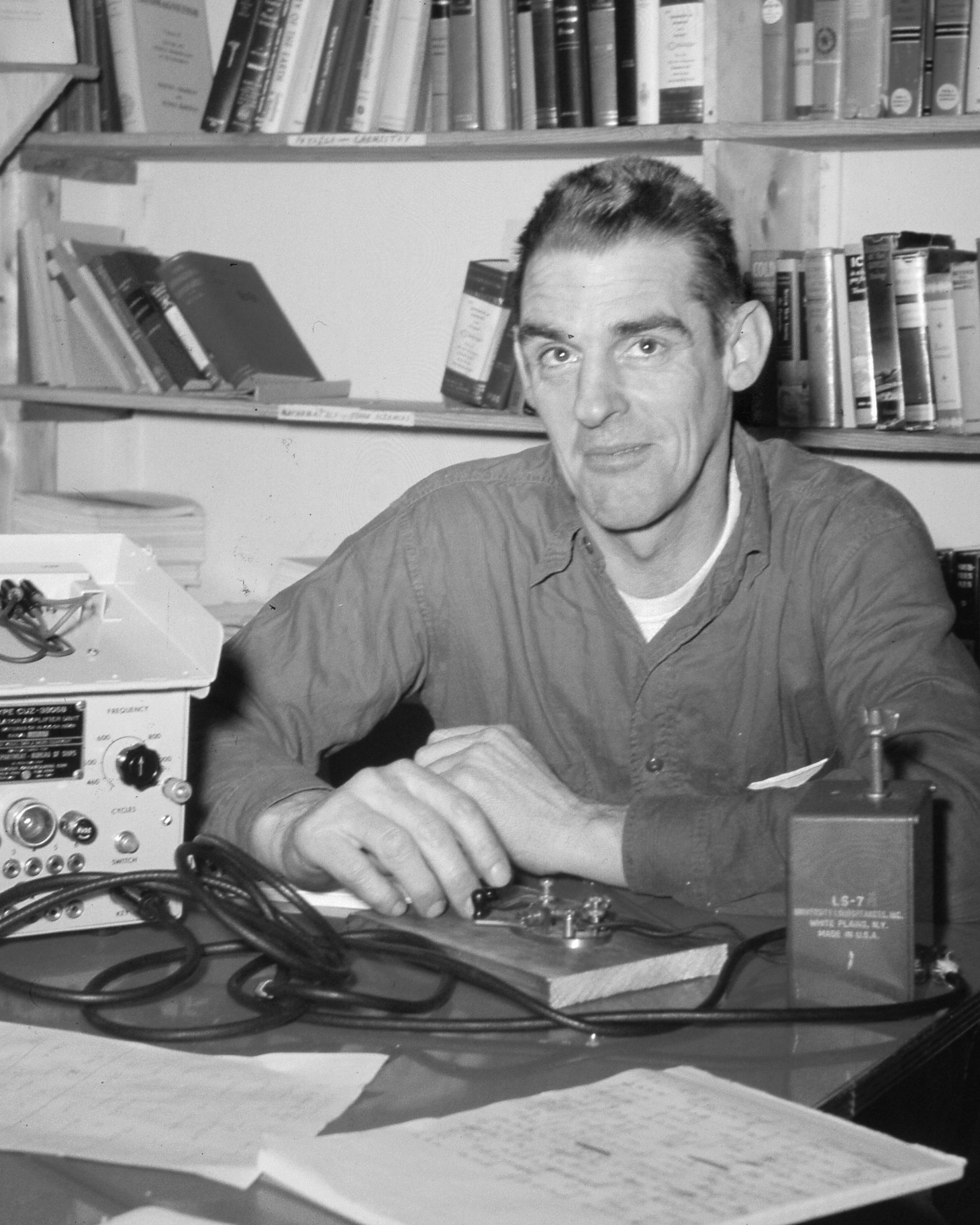 A man sits at a desk.