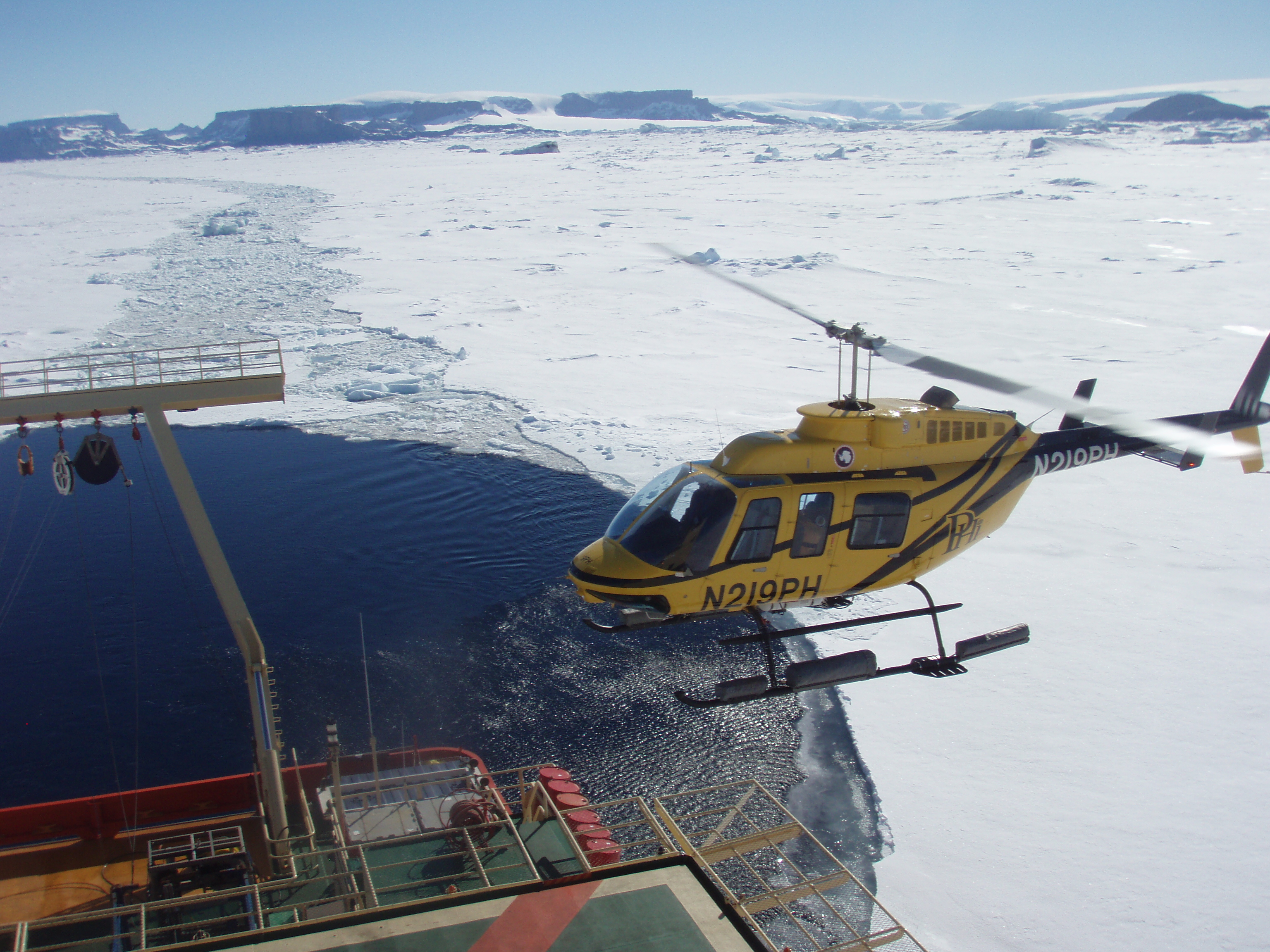 Helicopter lands on a ship.