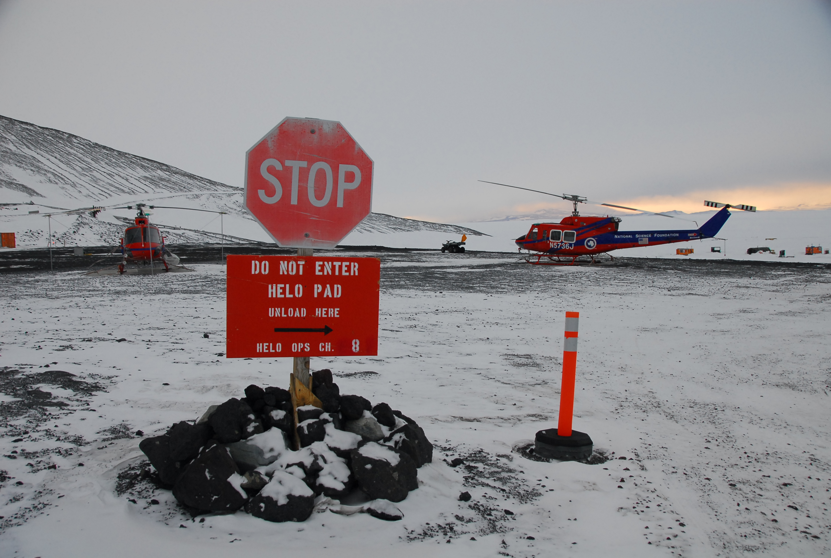 Stop sign warns visitors to helo pad.