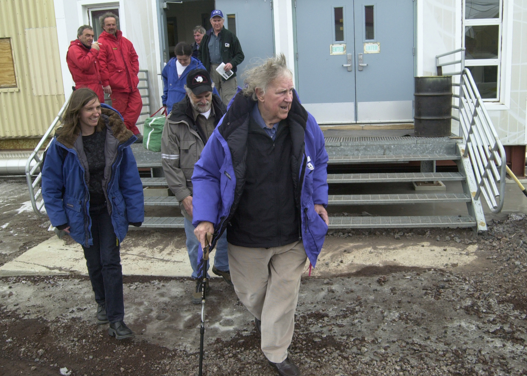 A group of people leave a building.