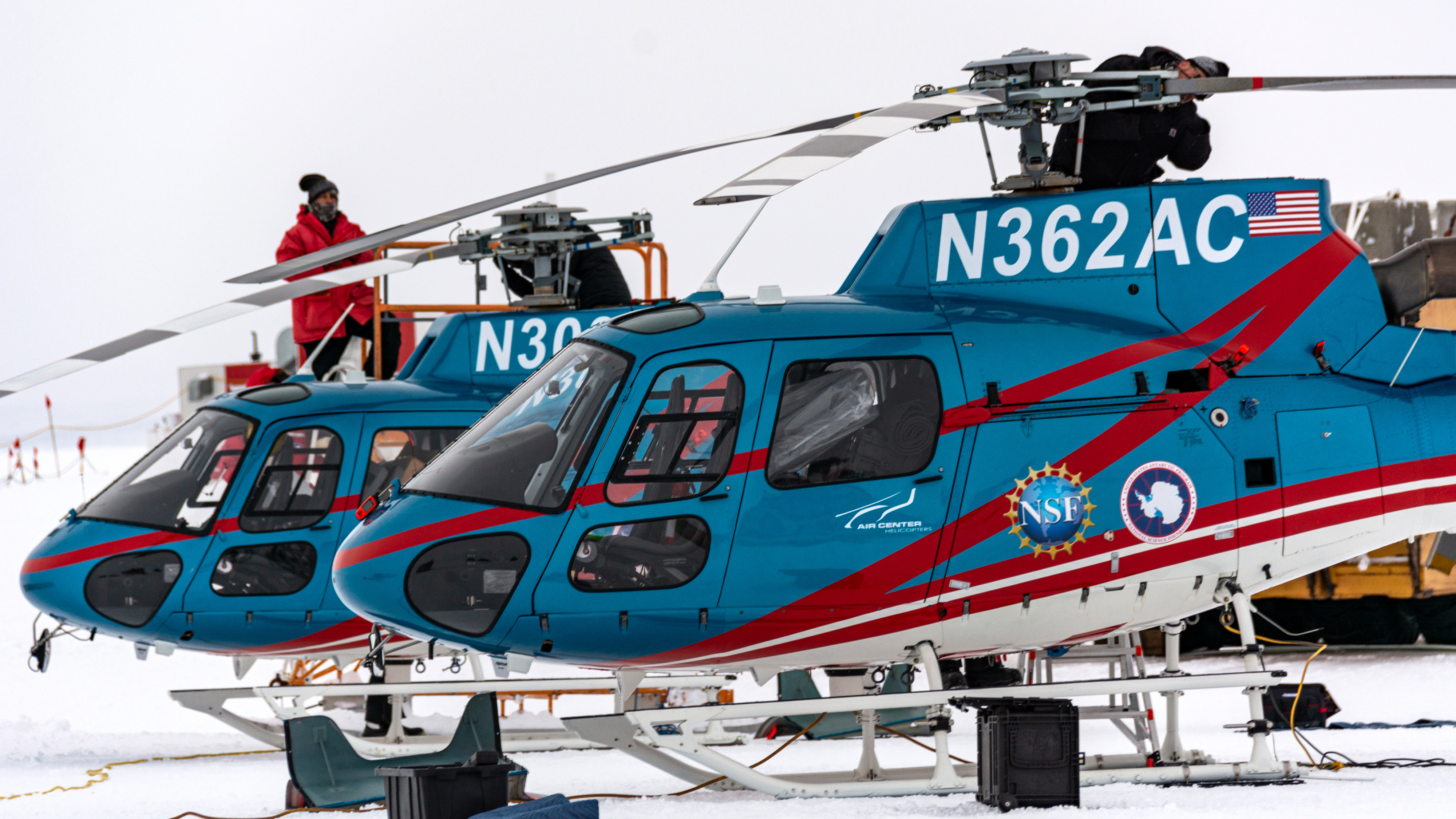 Two helicopters in a frozen landscape.