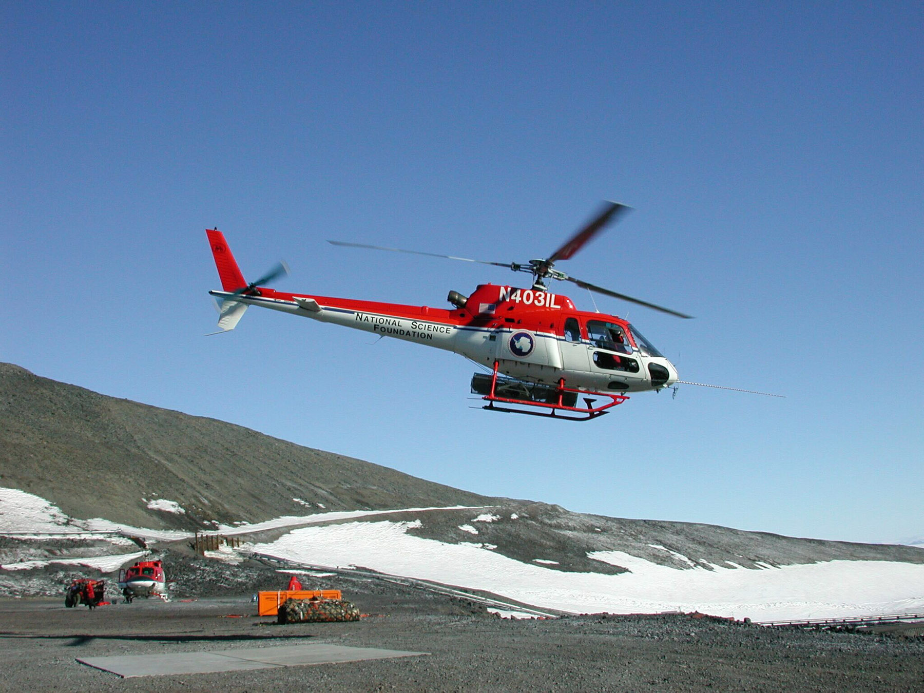 A red and white helicopter takes off.