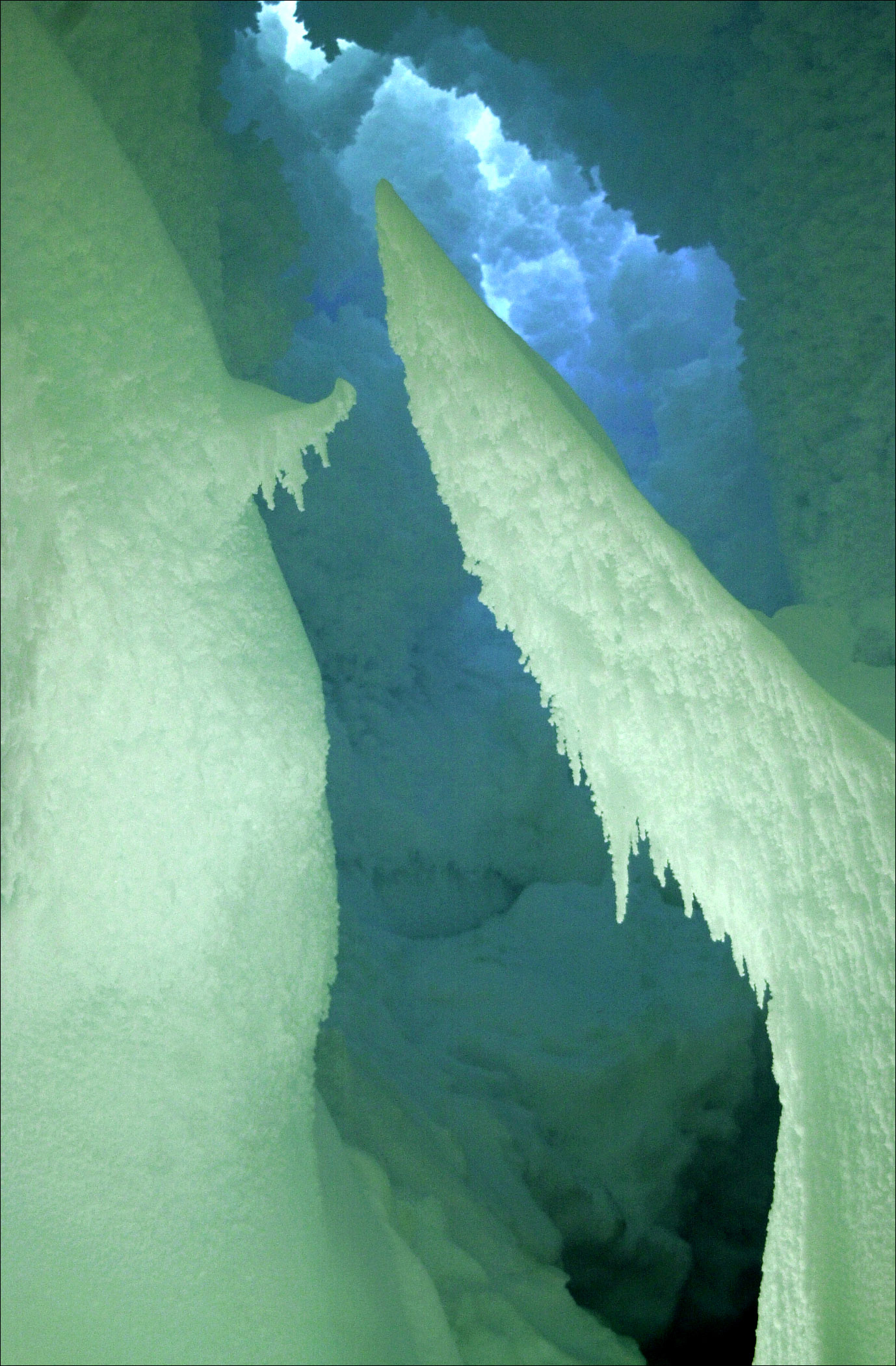 Bluish-green interior of a cave inside the ice. 