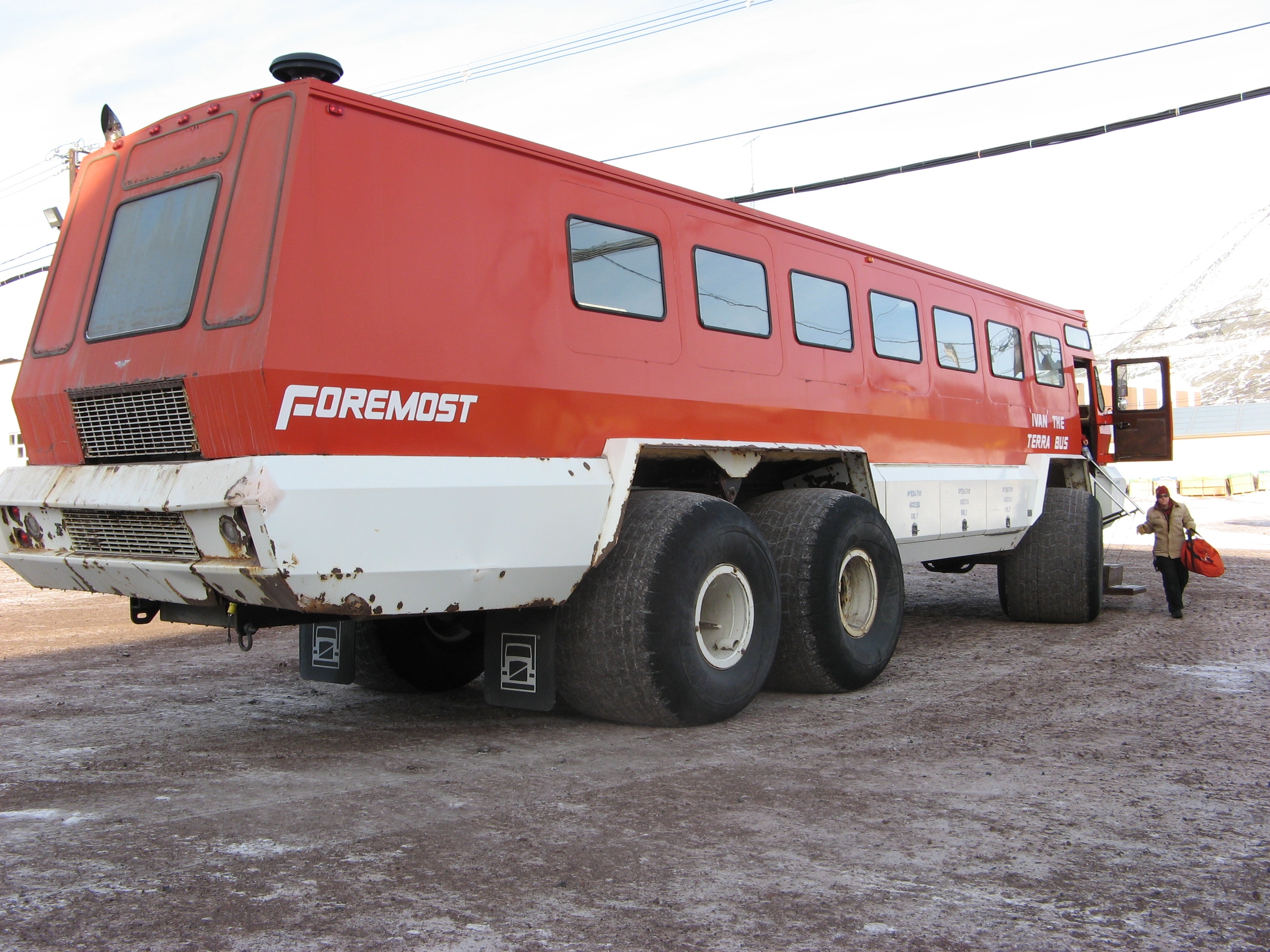 A person prepares to board a large bus.