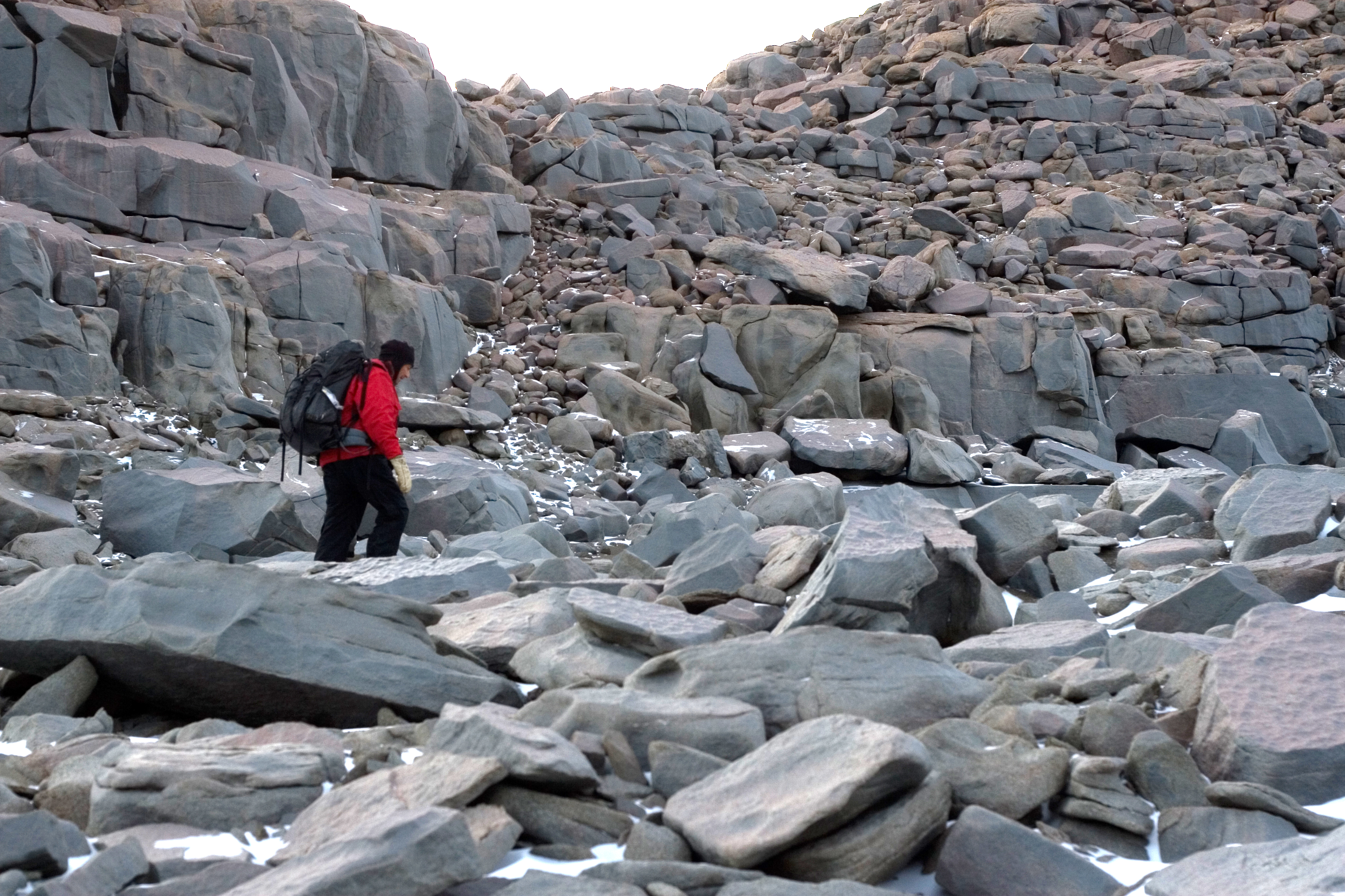 Person walks in rocky area.