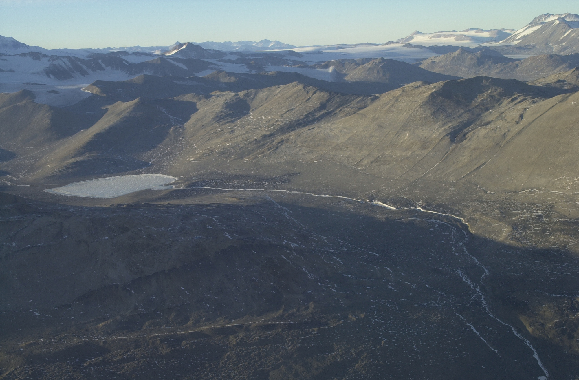 A lake in a brown mountain valley.