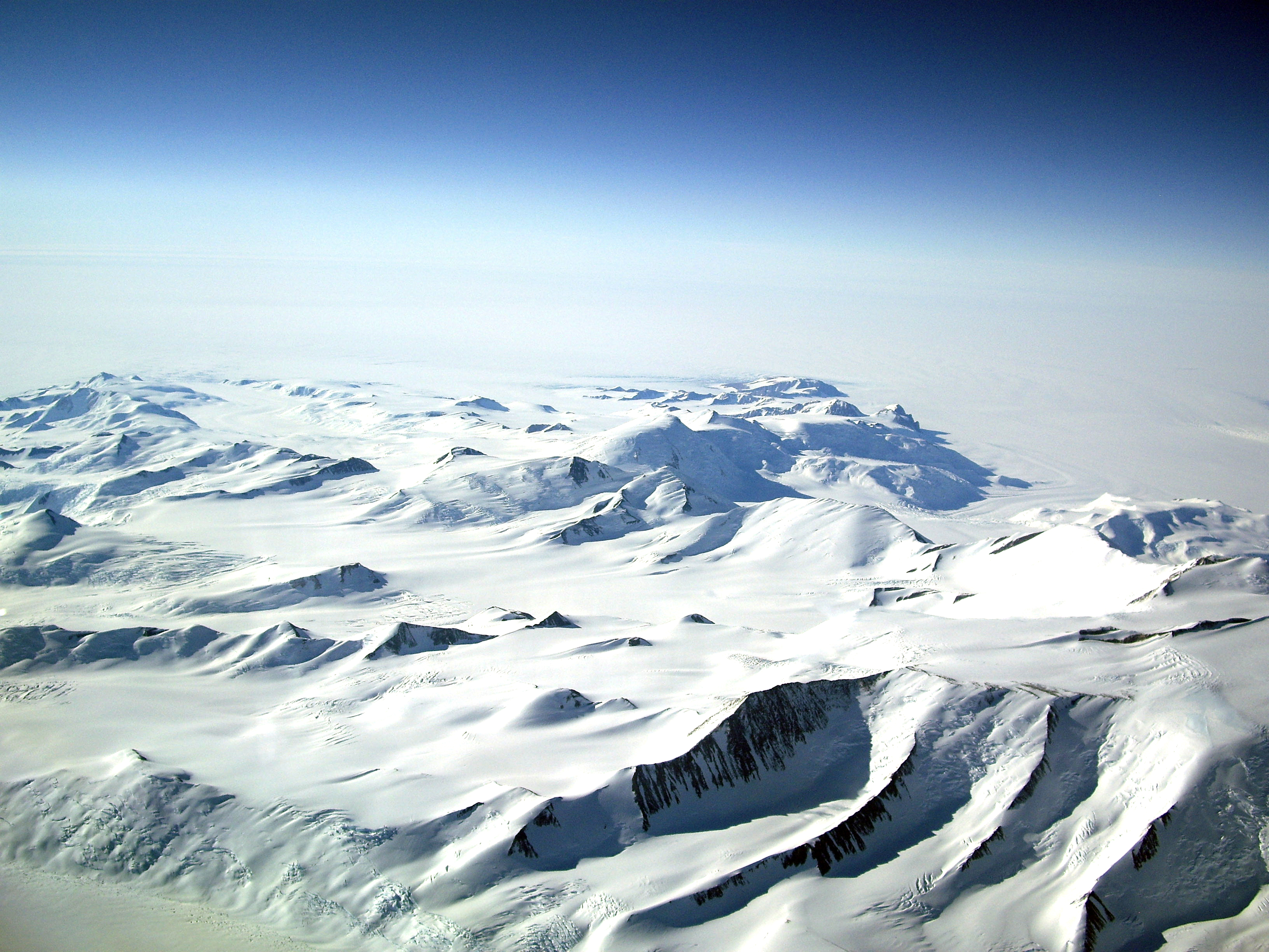 Aerial view of snow covered mountains.