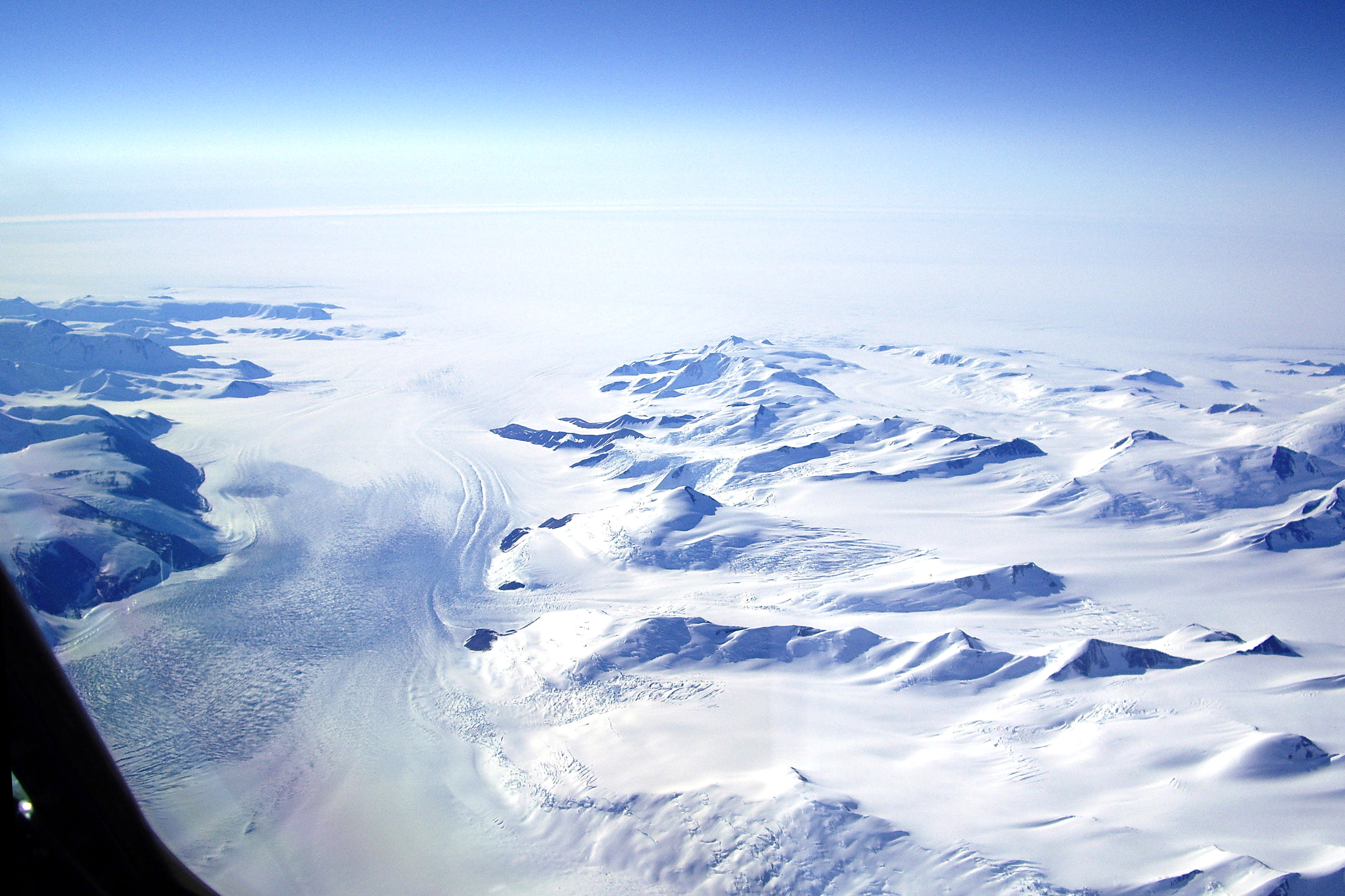 Aerial view of snow covered mountains.