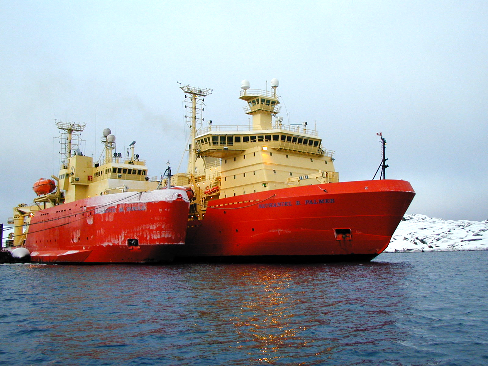 Two ships dock next to each other.