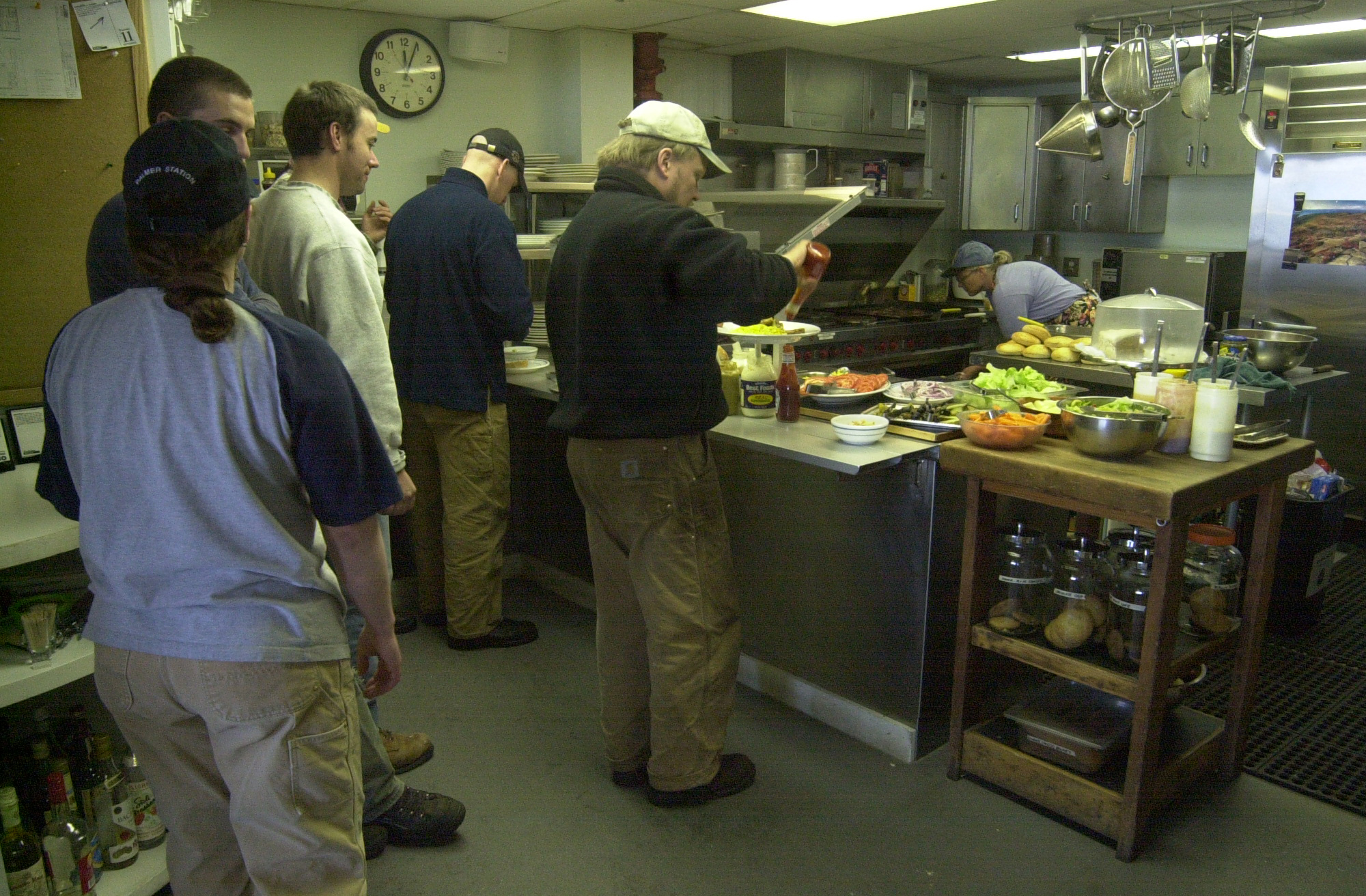 Line of people waiting to get food.