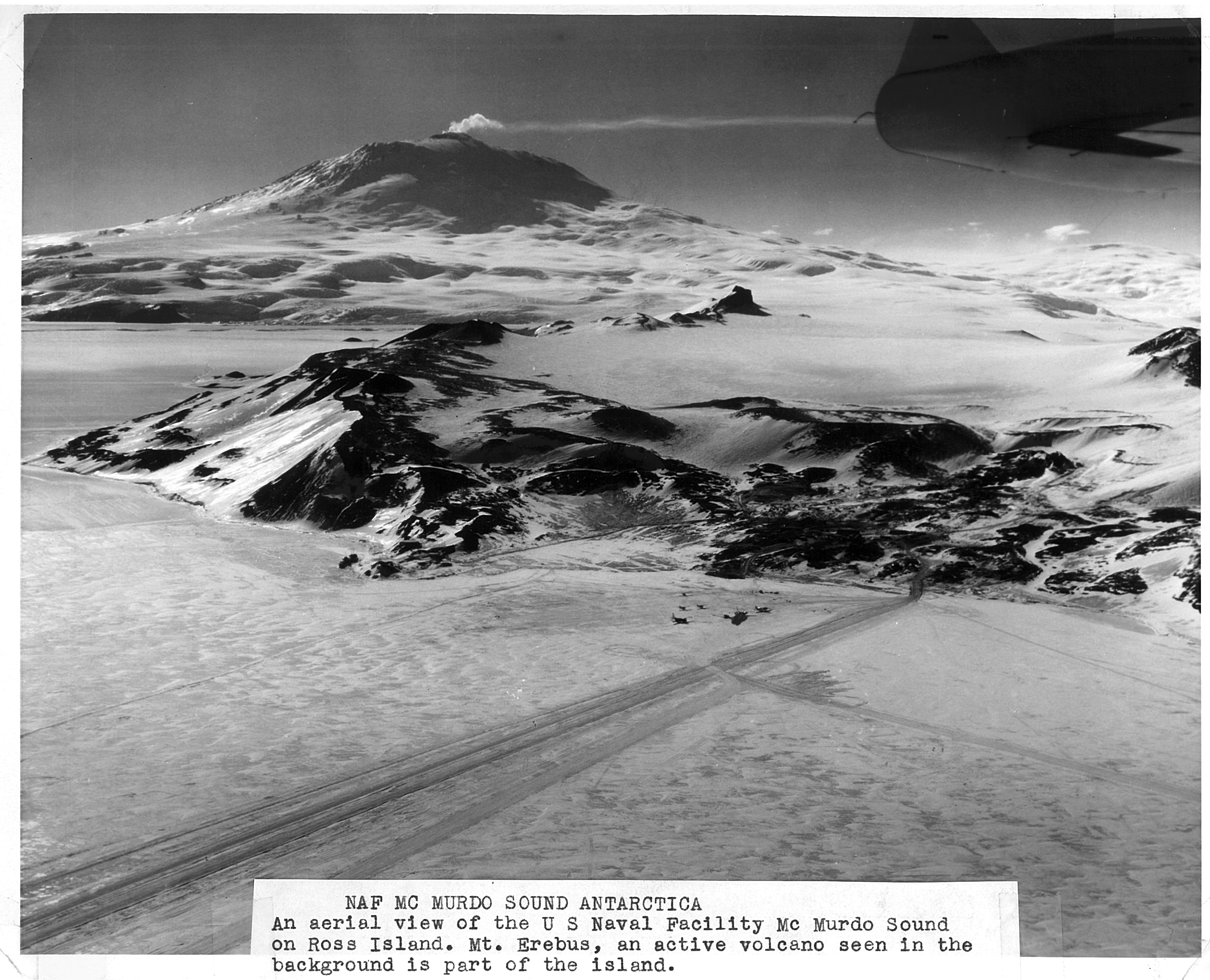 Aerial view of a town, rocks and snow.