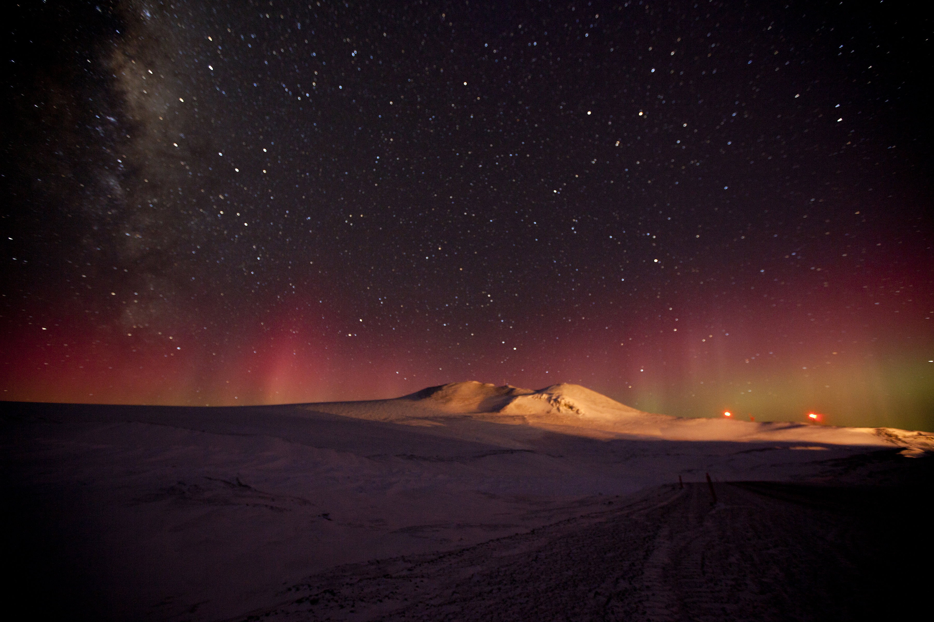 Auroras and Milky Way illuminate the night sky over Ross Island.