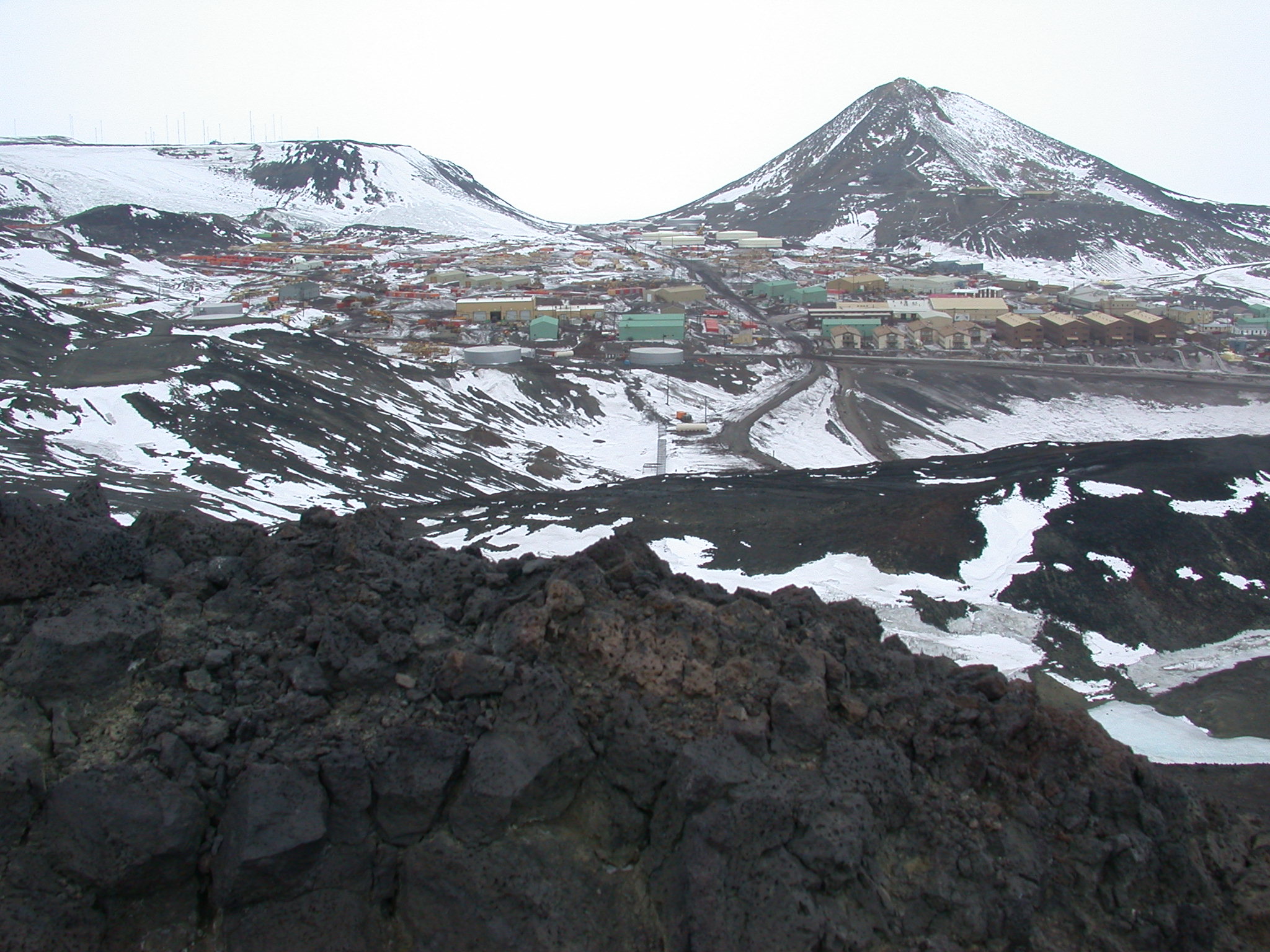 Buildings in front of hill.