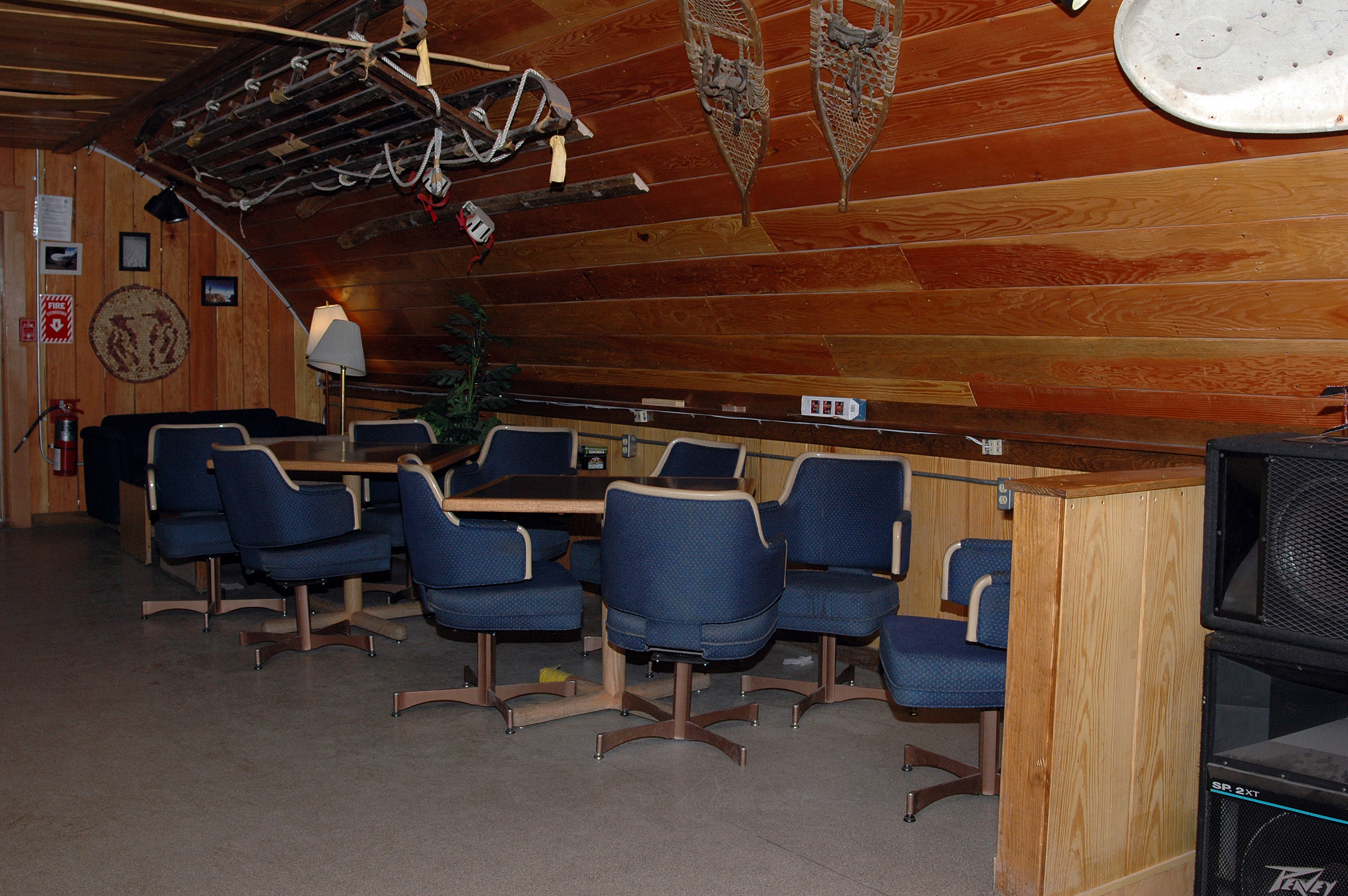 Tables and chairs in a room.