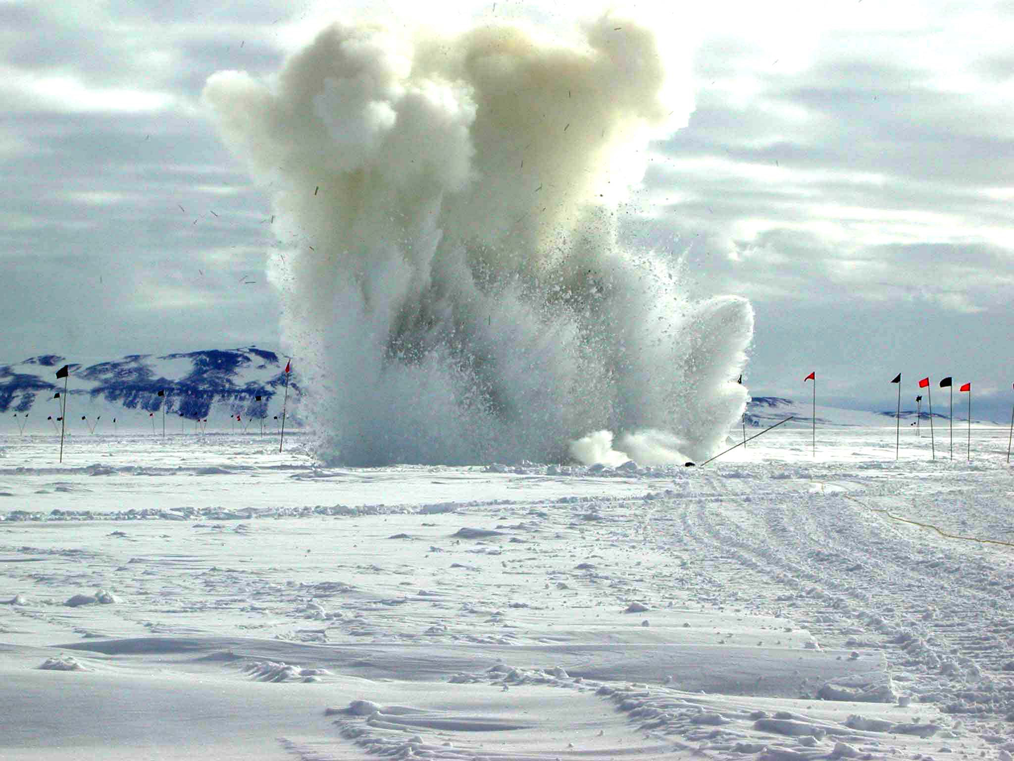 A plume of snow is emitted from an explosion.