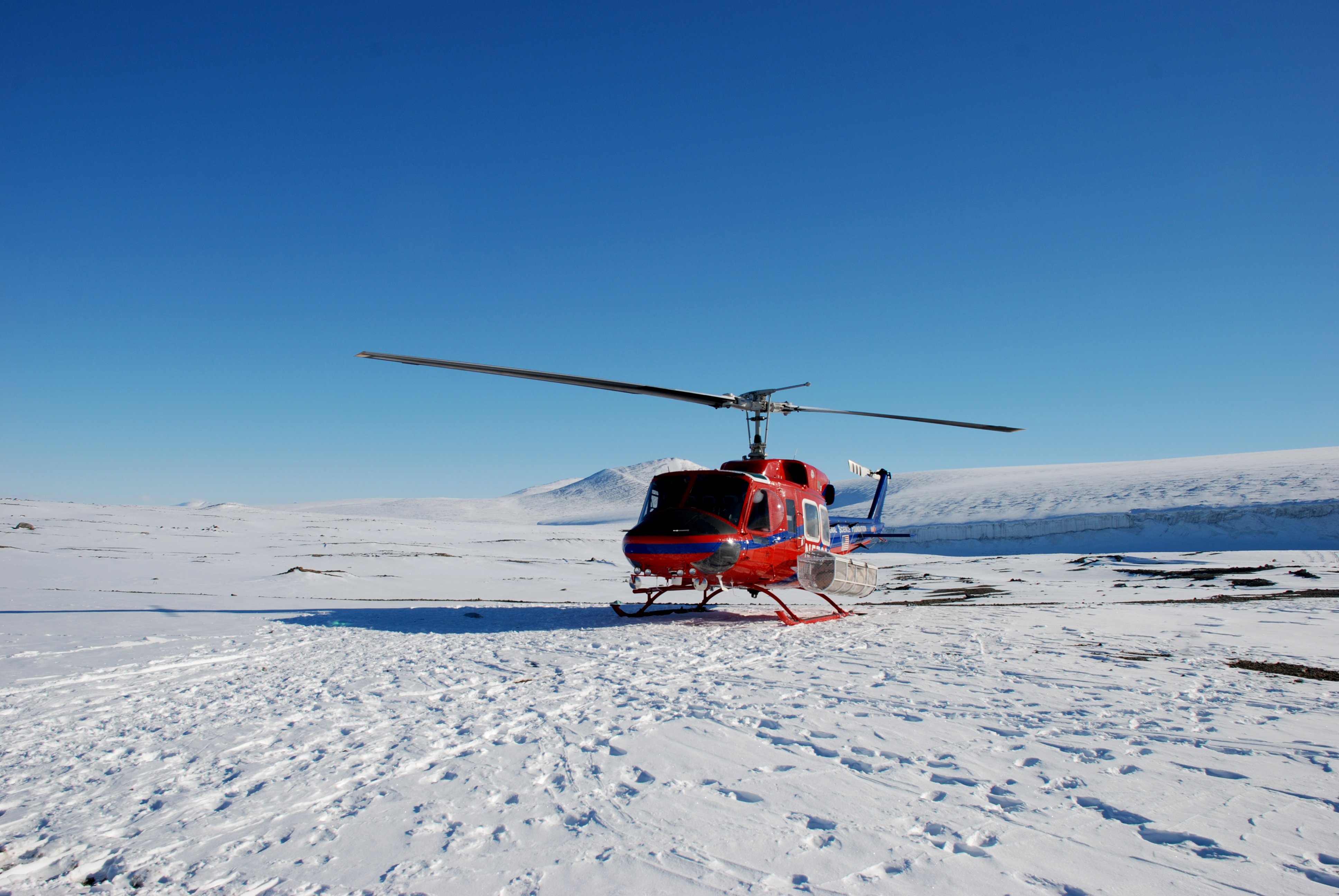 A  helicopter on snow-covered ground.