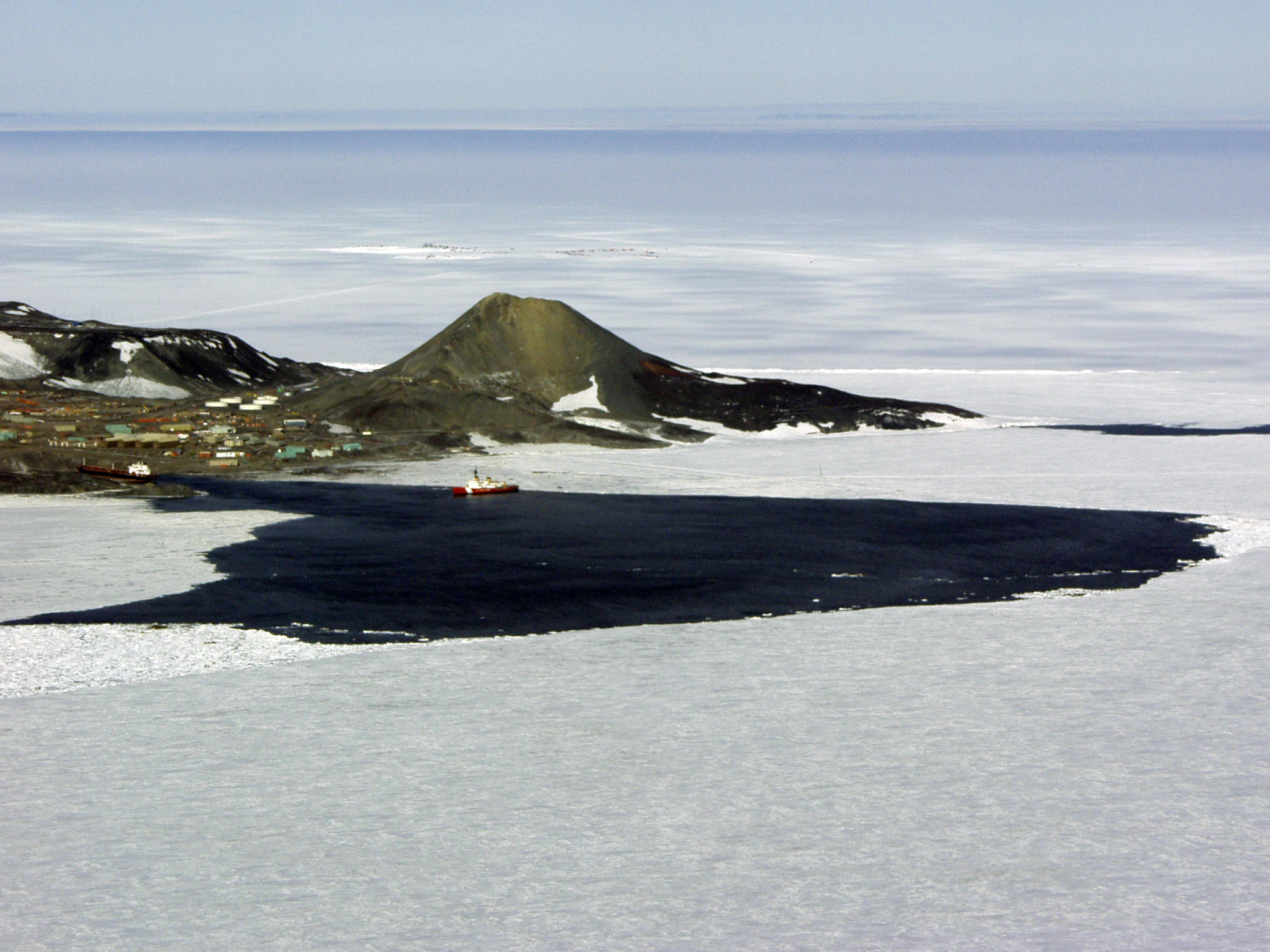 Aerial of land, ocean and ice.