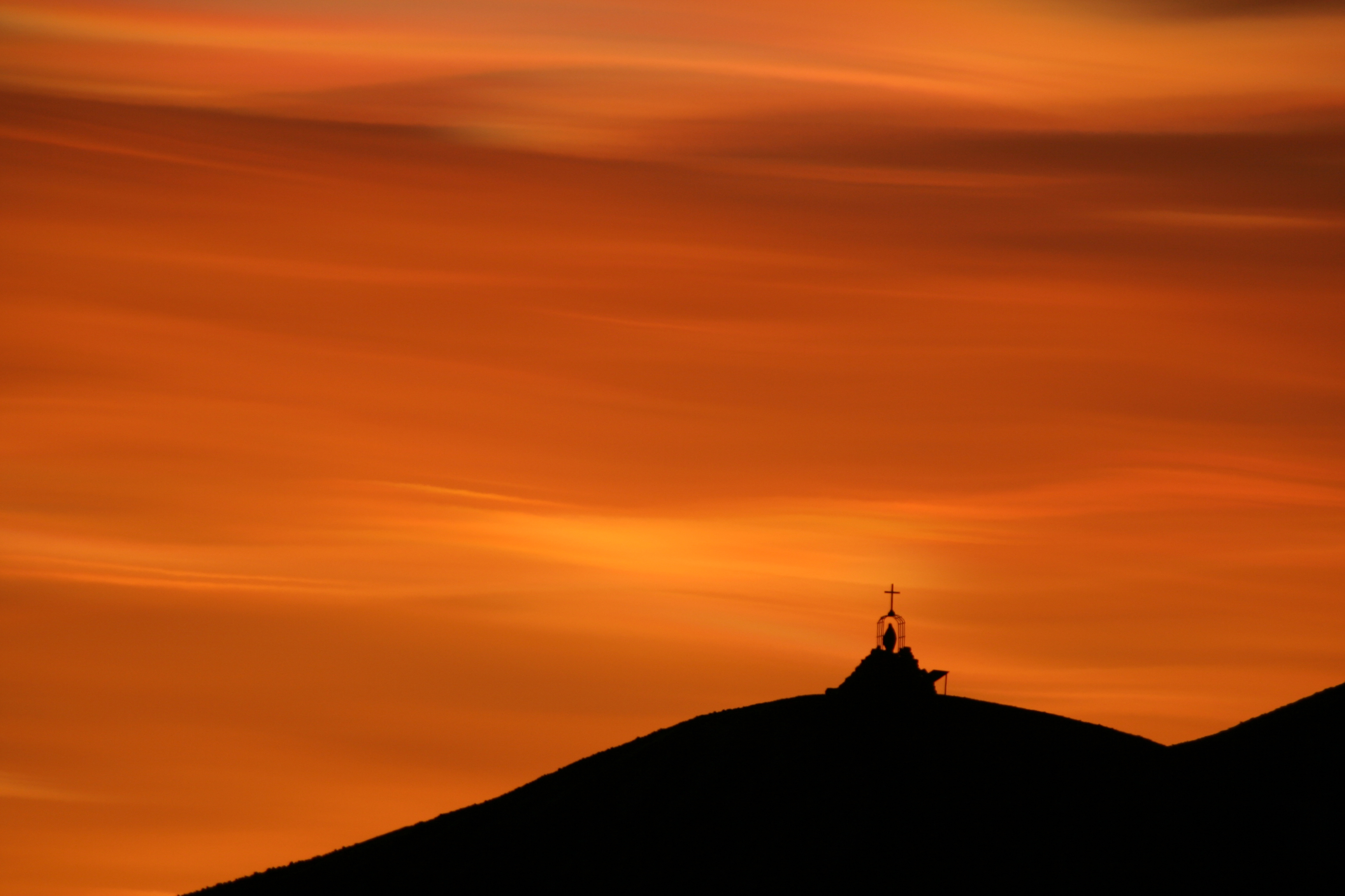 Orange clouds appear over memorial.