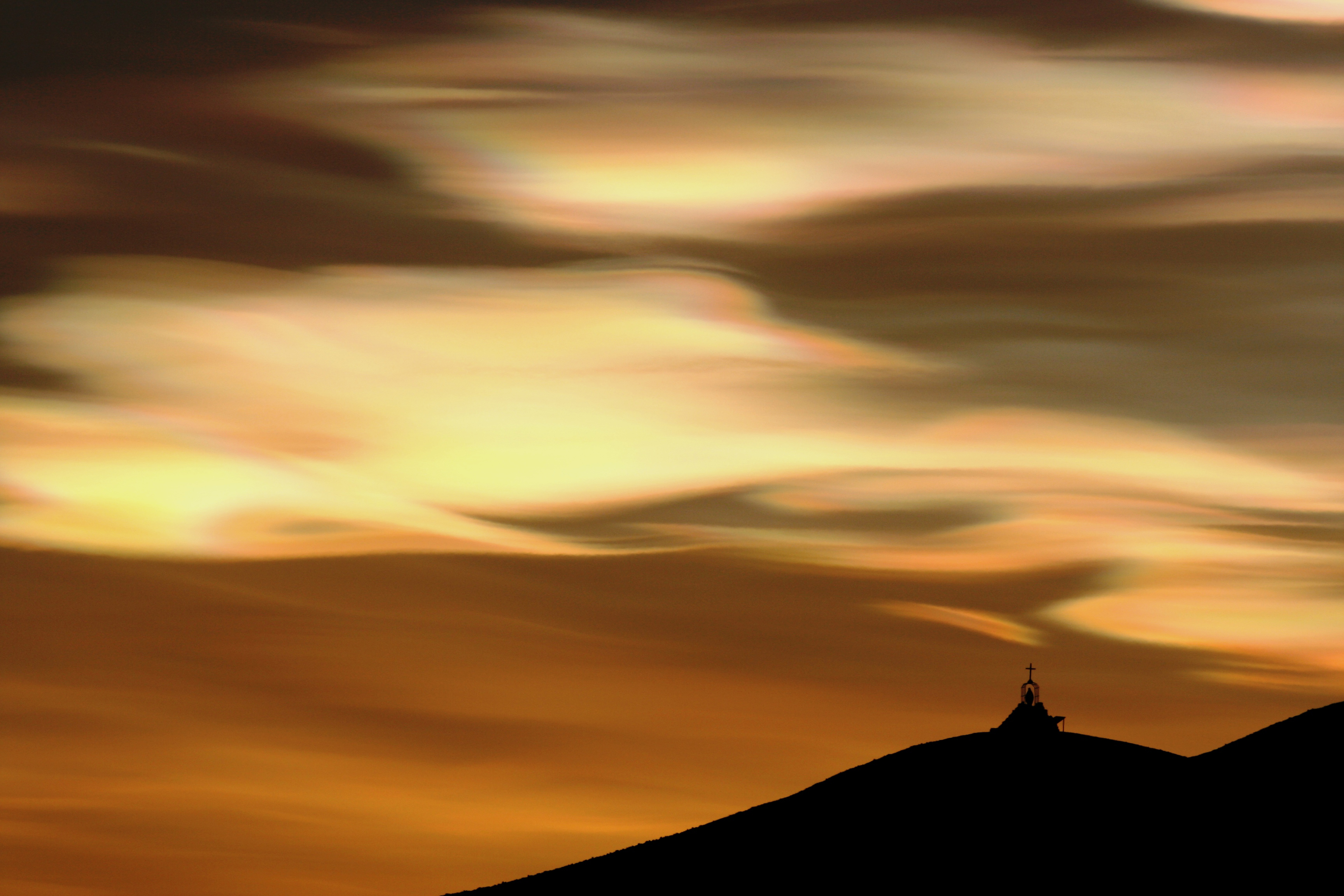 Orange clouds appear over memorial.