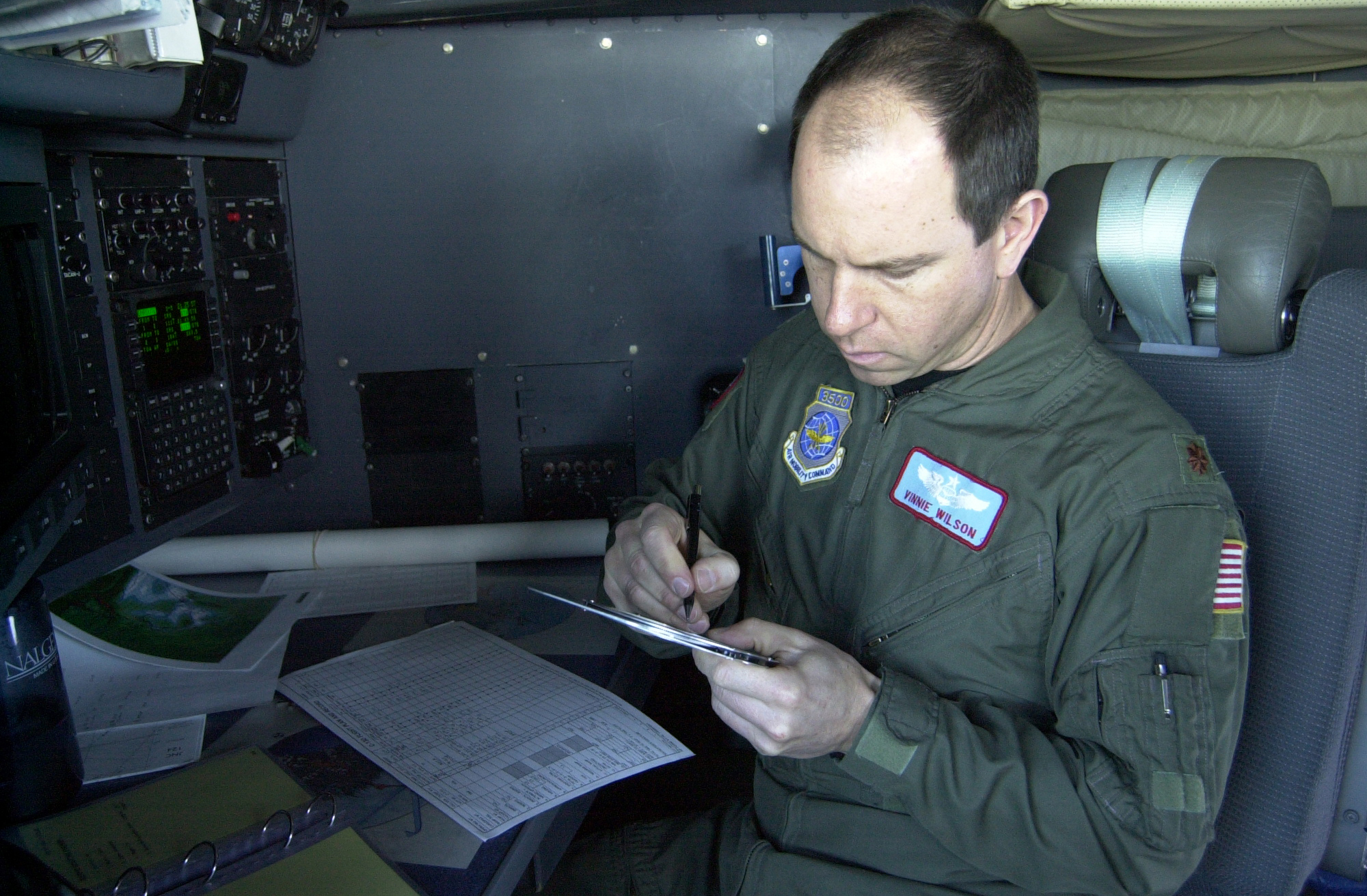 A military pilot in a cockpit.