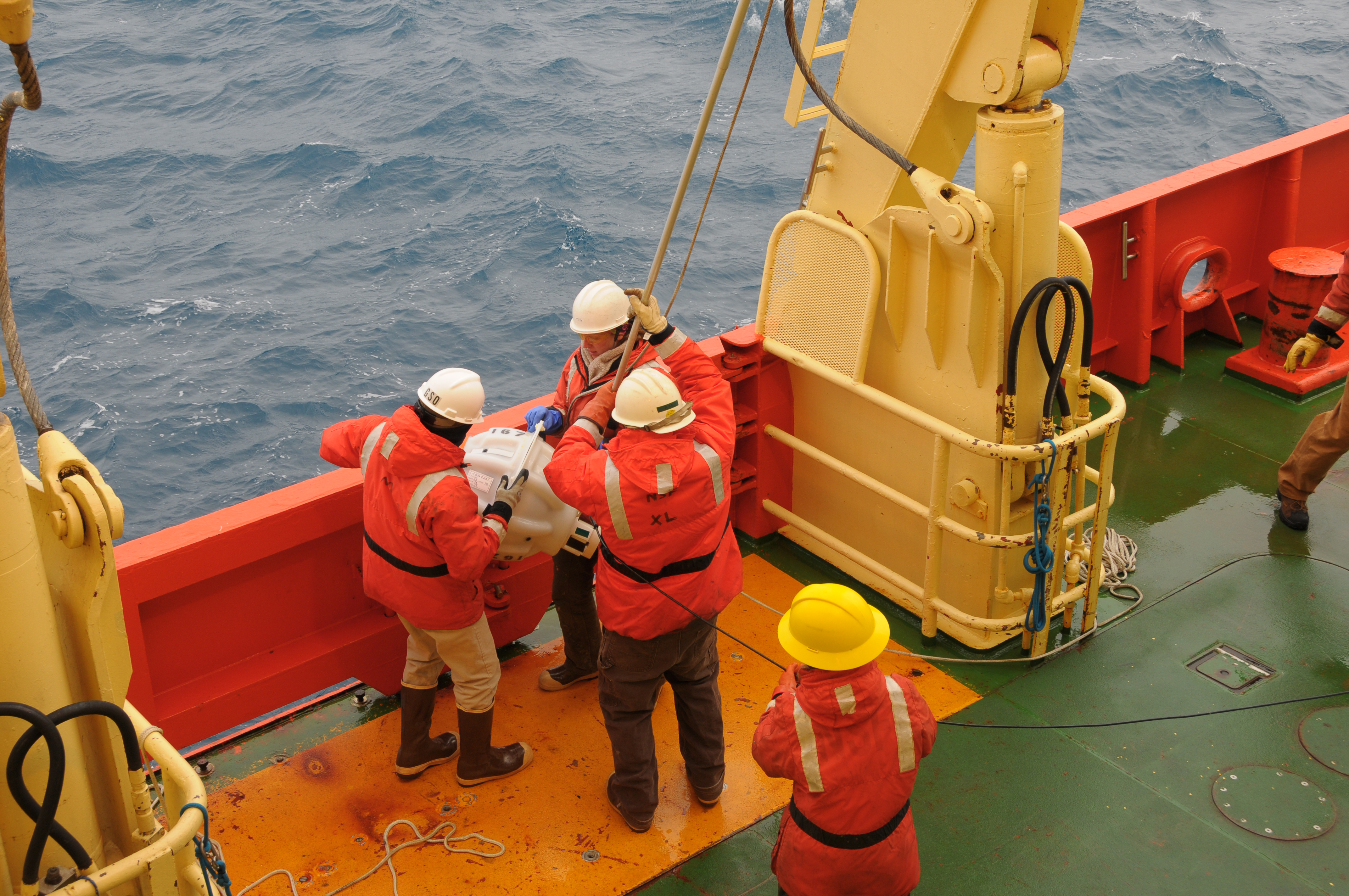 People working on deck of ship.