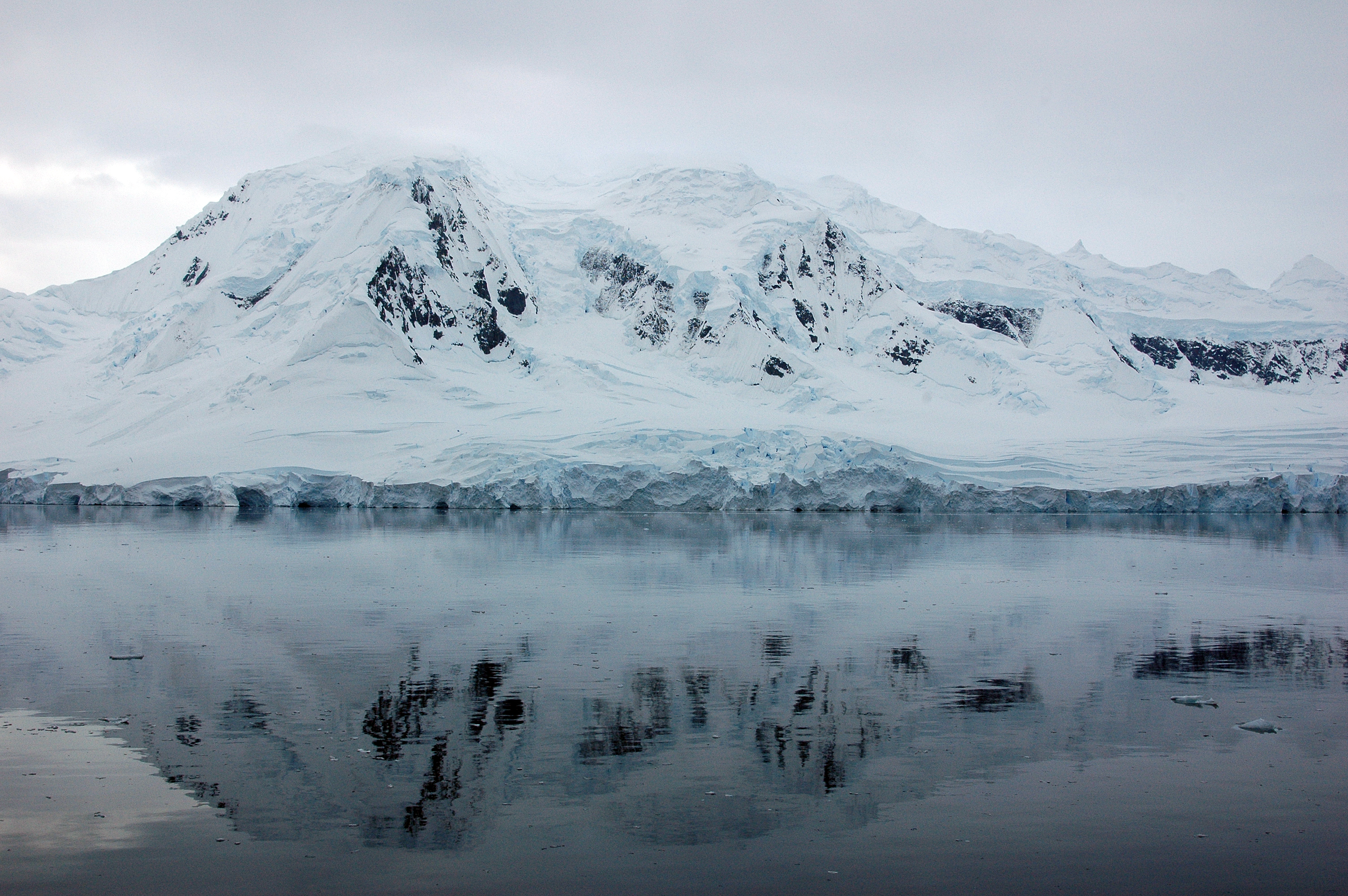 Mountains are reflected in the water.