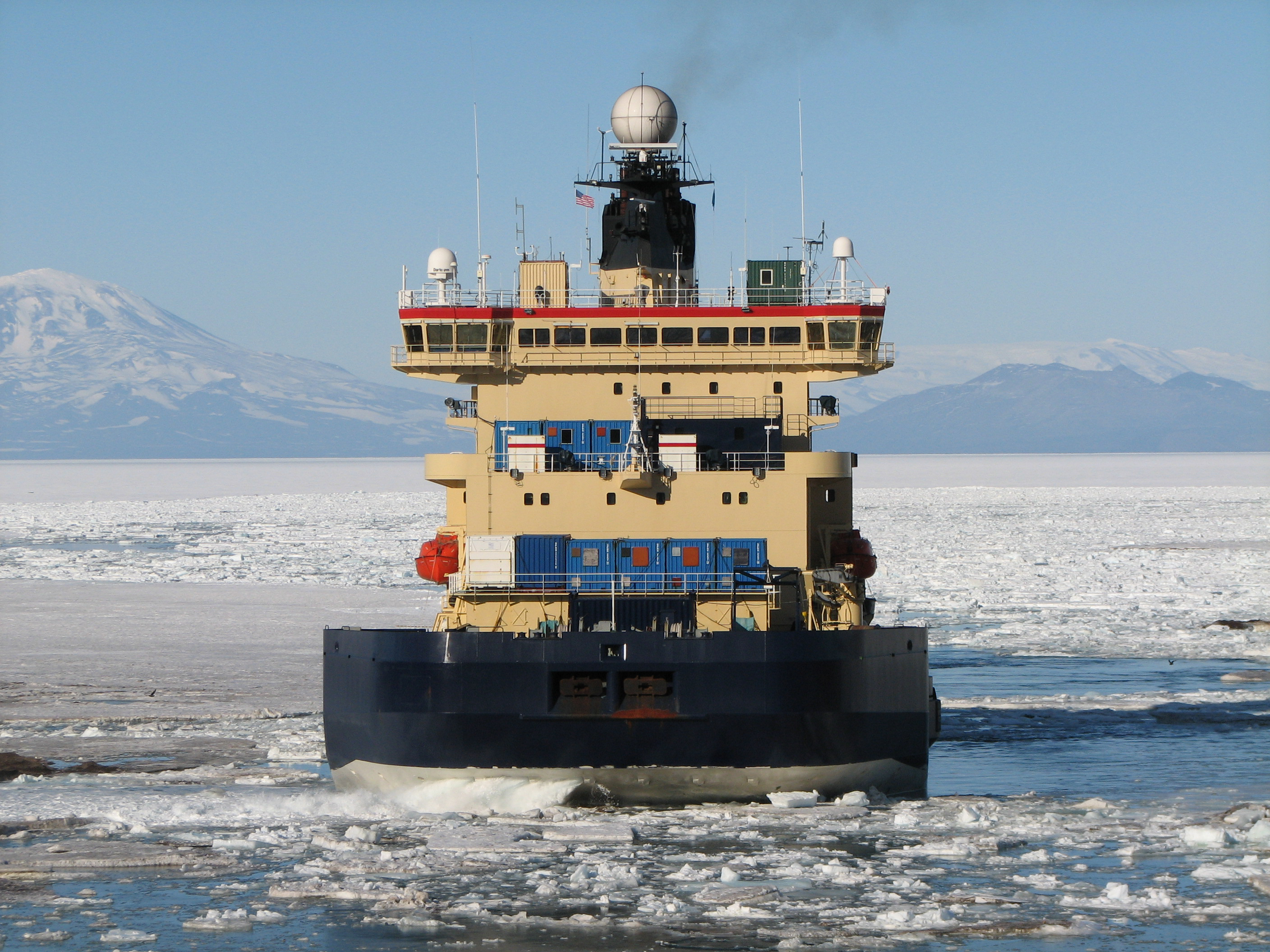 A ship sail in ice-covered waters.