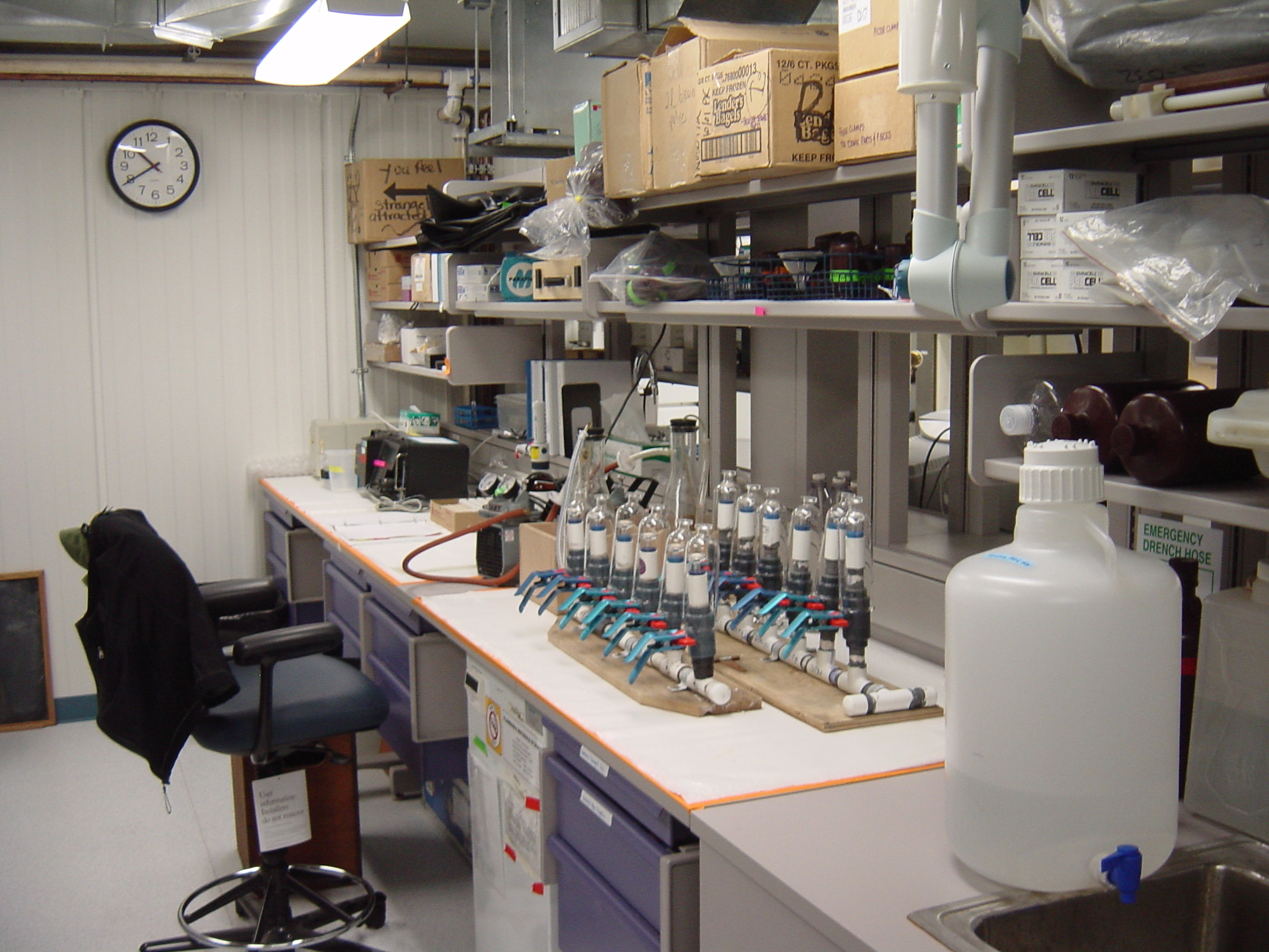 A desk and shelves filled with boxes and lab equipment.