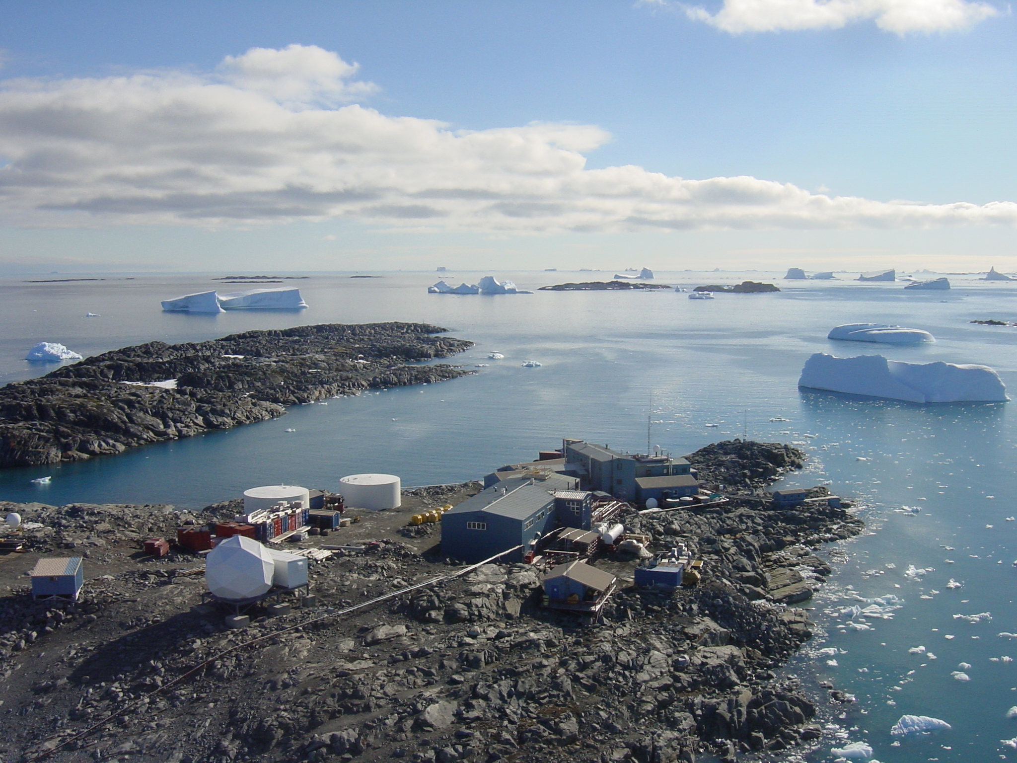 A cluster of buildings sit near the water.