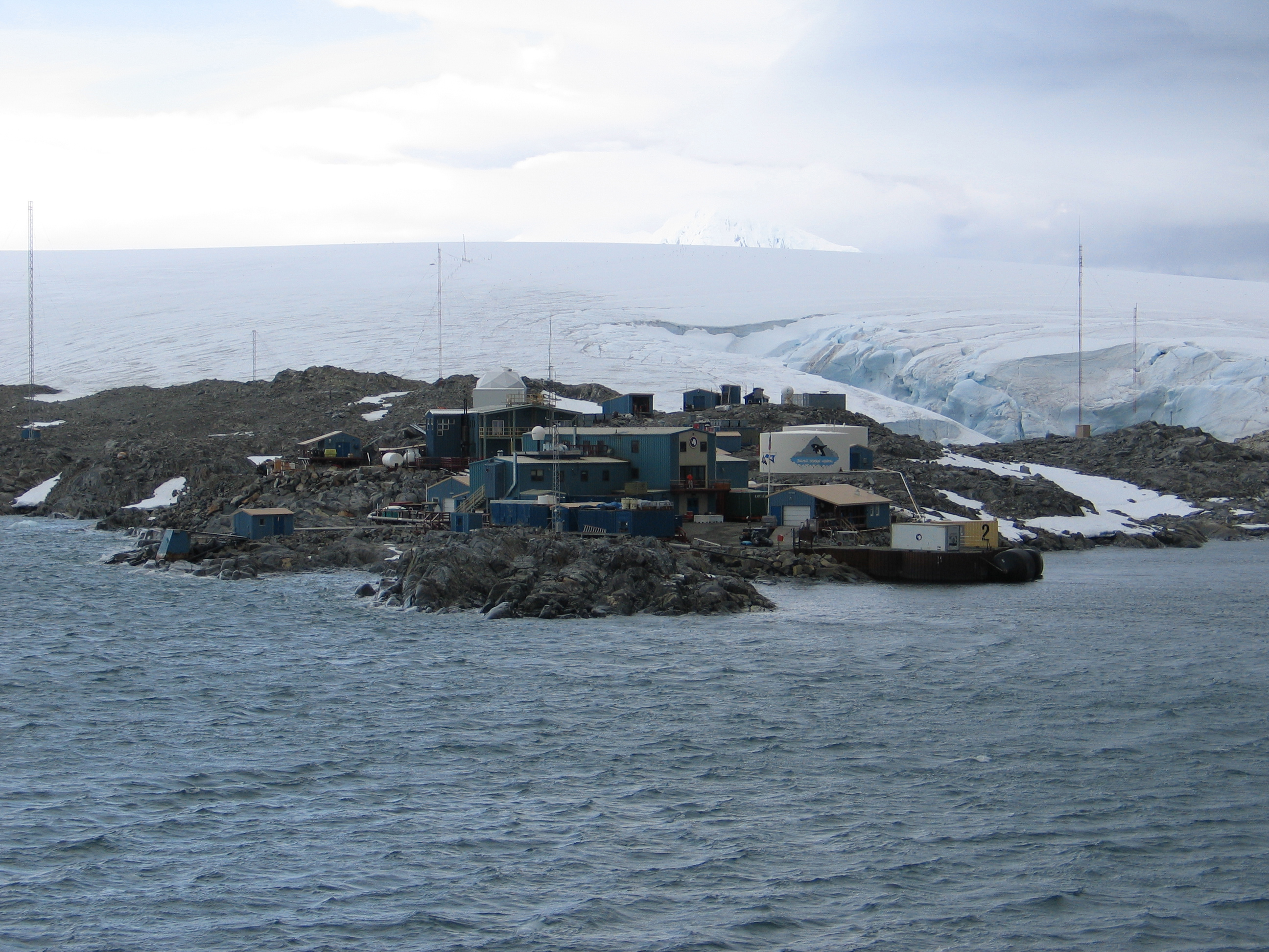 Blue buildings on a rocky cape.