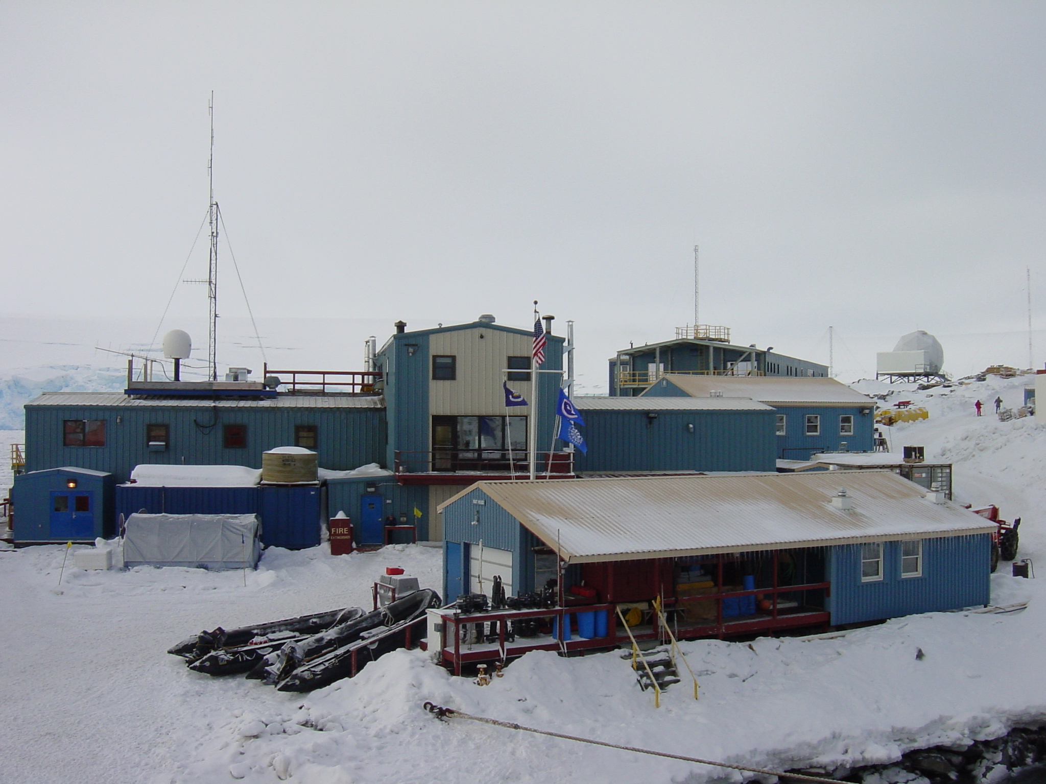 A group of buildings on a snowy surface.