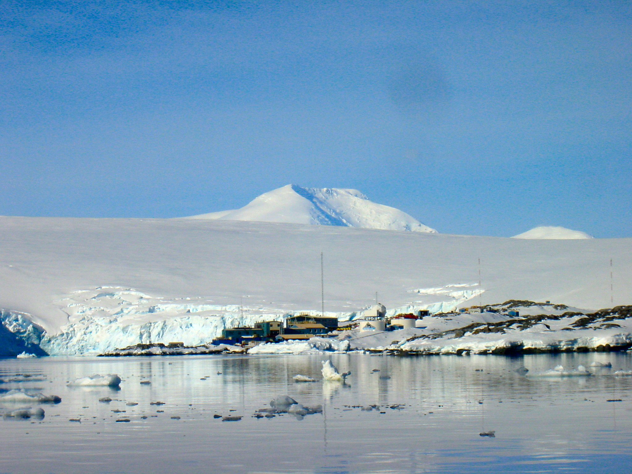 A cluster of buildings sit near the water.