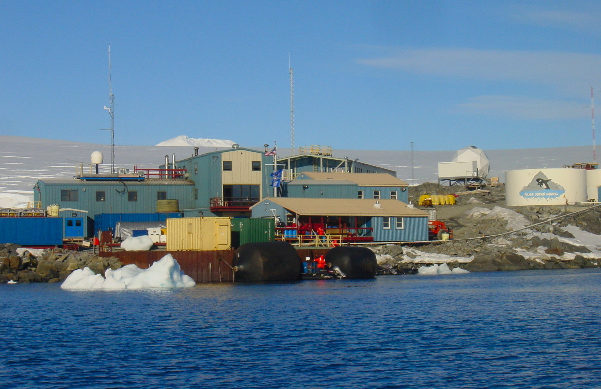 A cluster of buildings sit near the water.