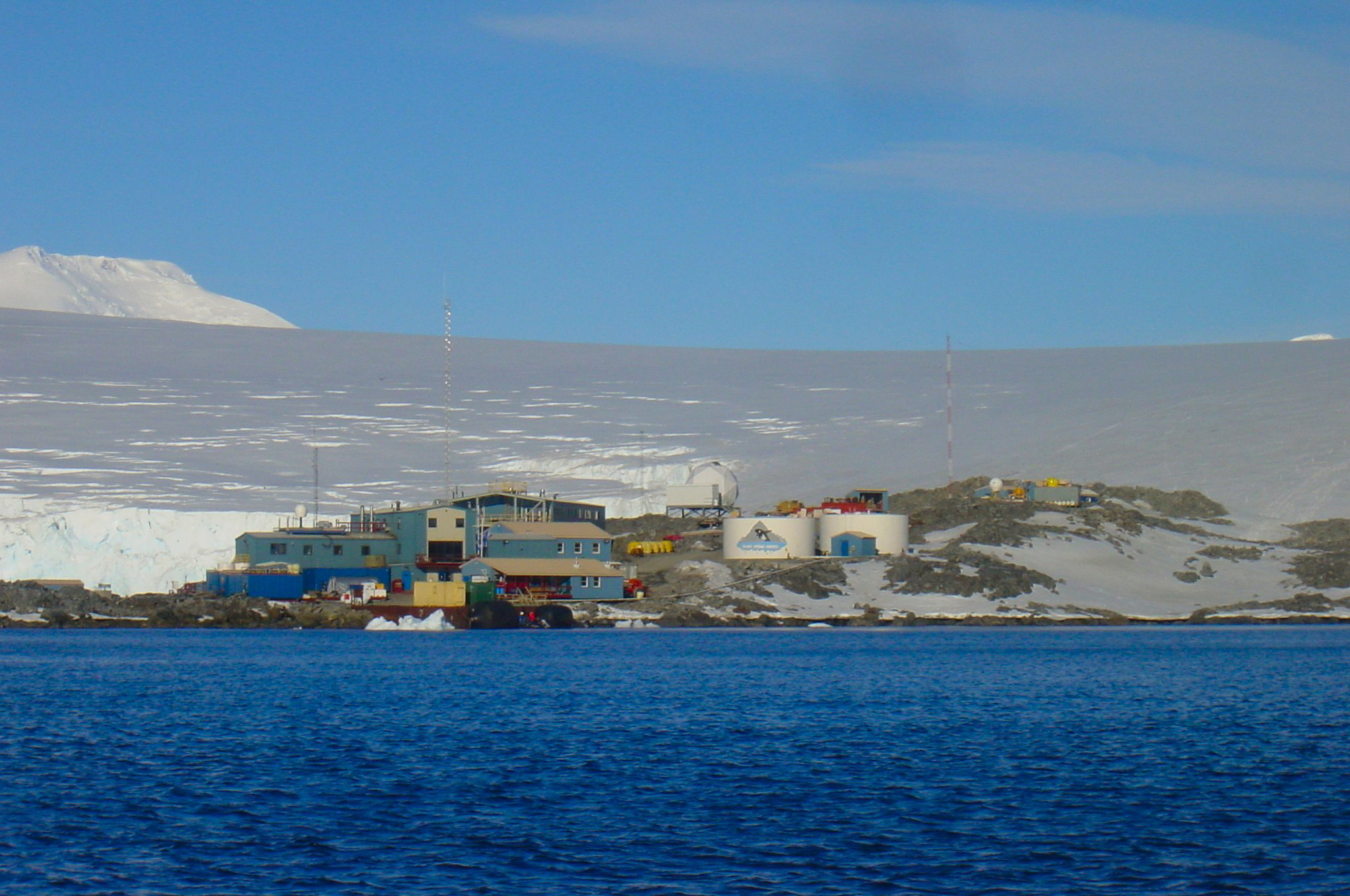 A cluster of buildings sit near the water.