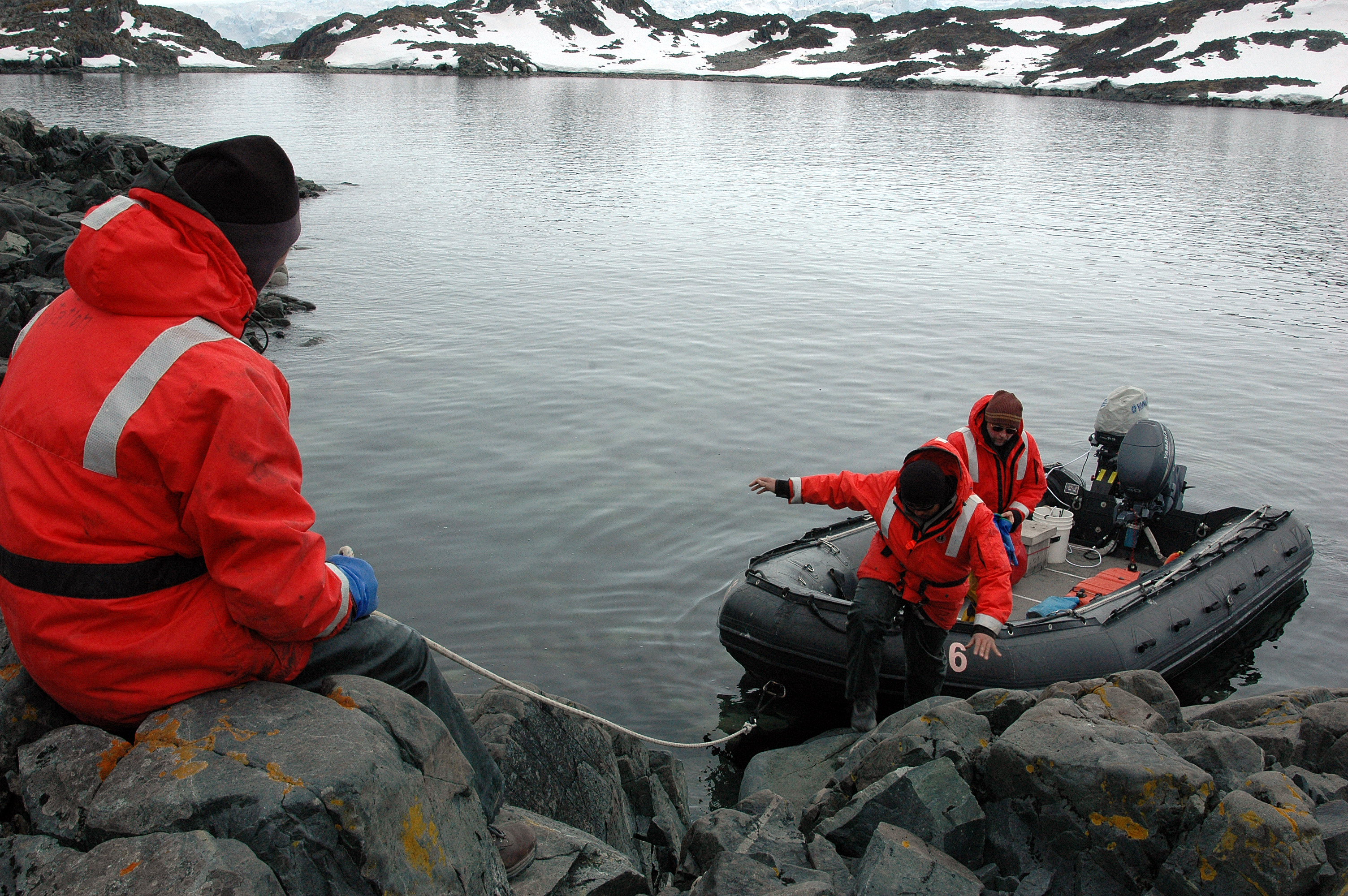 People get out of a small boat.