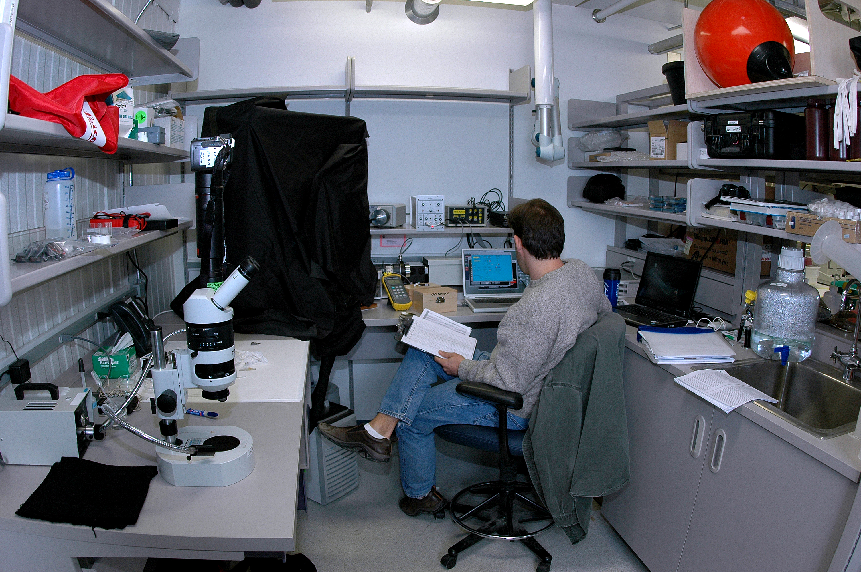 A man sits in a small office.