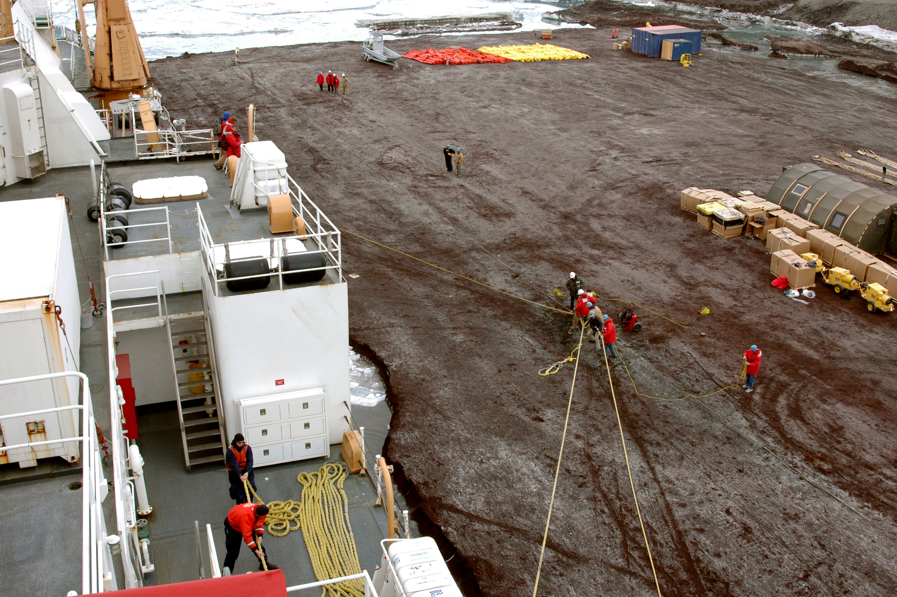 People hold lines from ship.