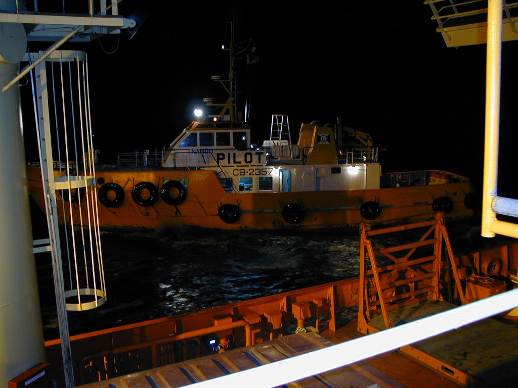 A small boat next to a larger boat.