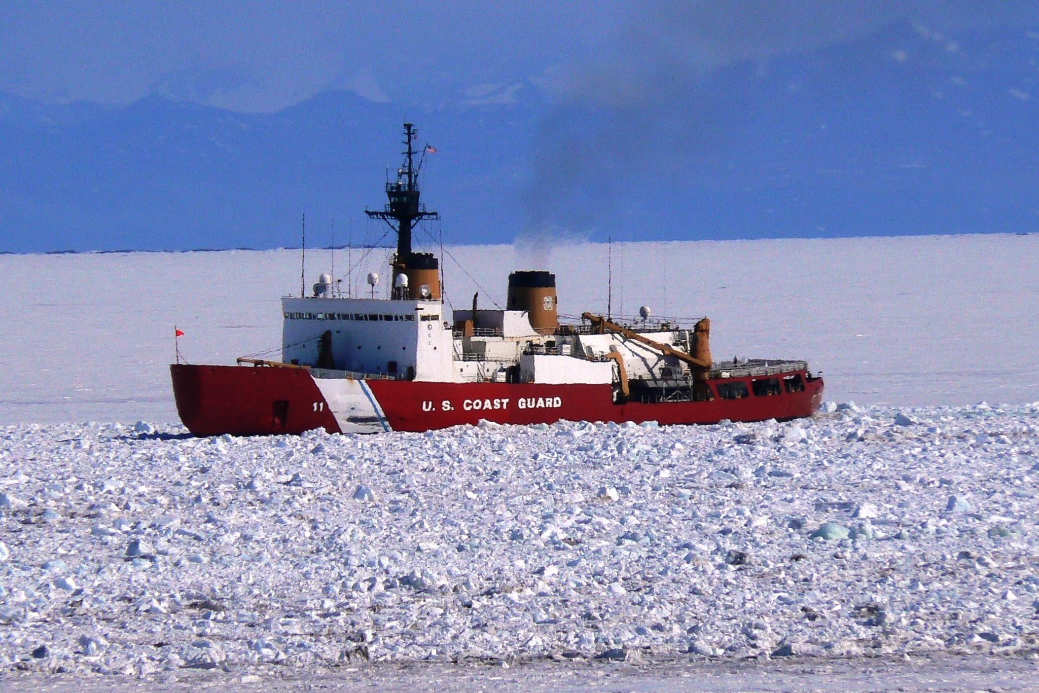 A ship saisl through ice.