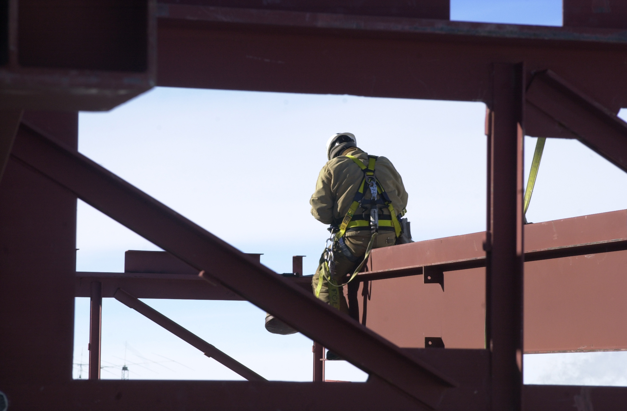 Man sits on steel beam