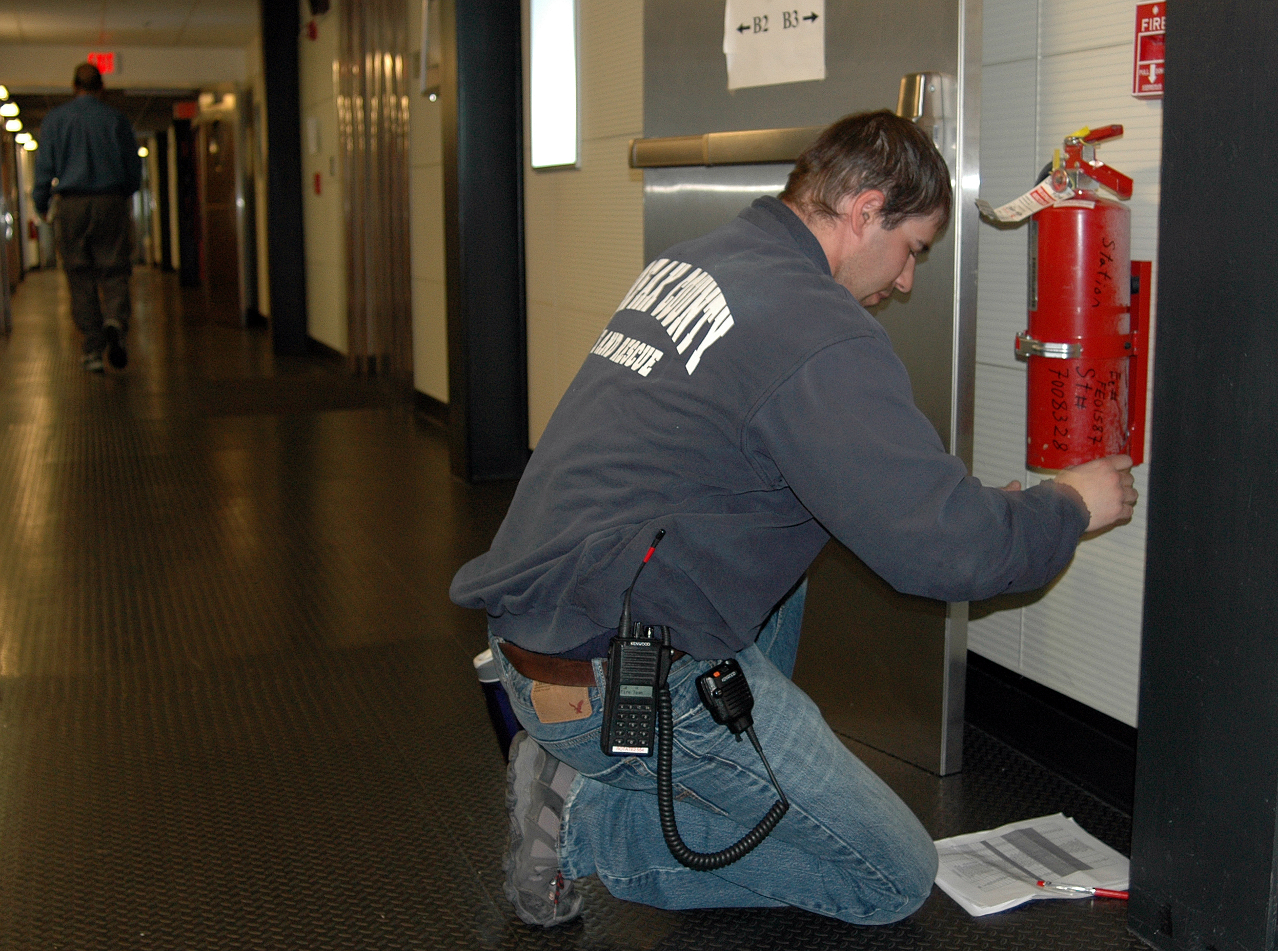 A man working with a fire extinguisher.