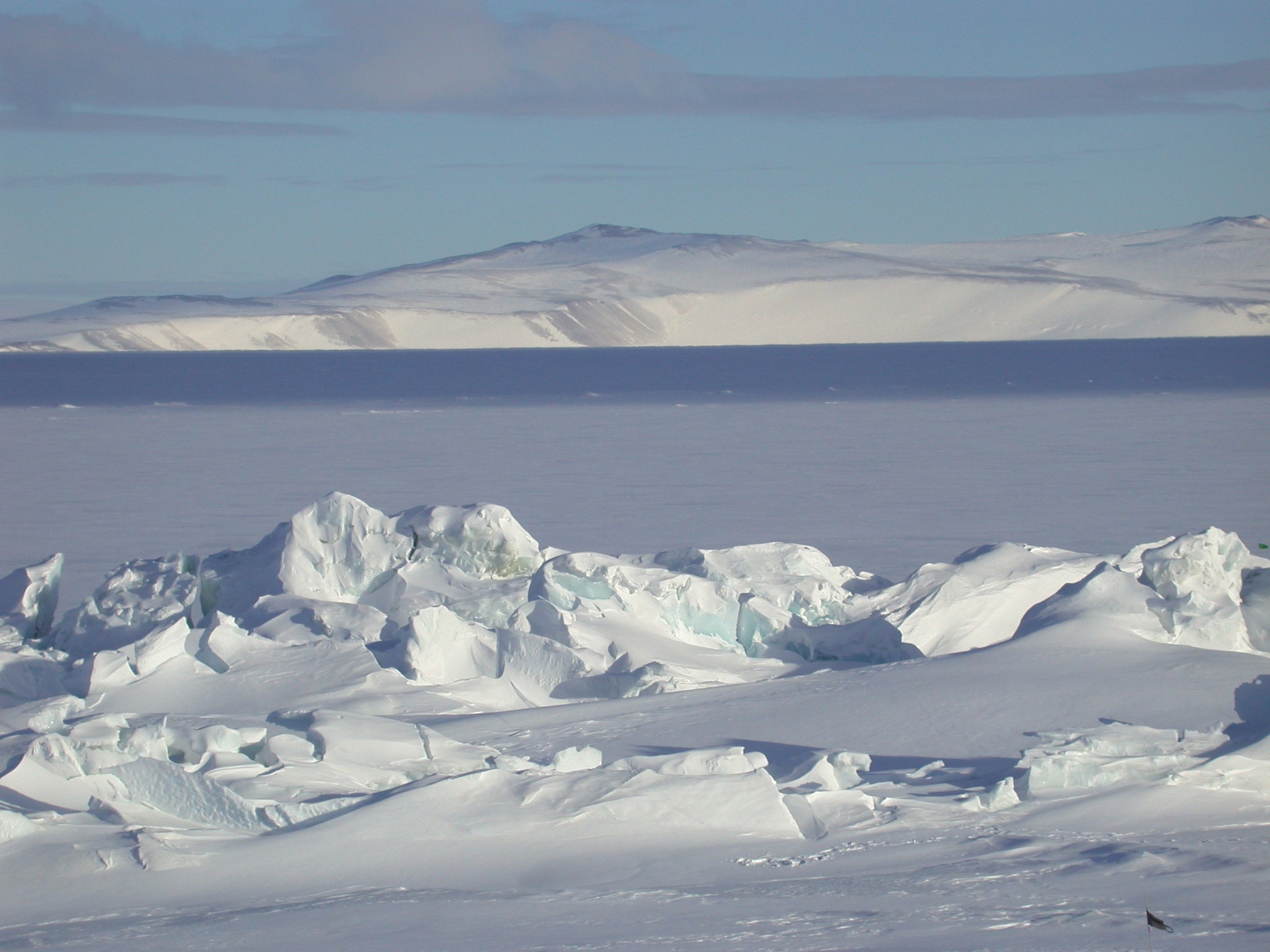 An upthrust of ice with a mountain in background.