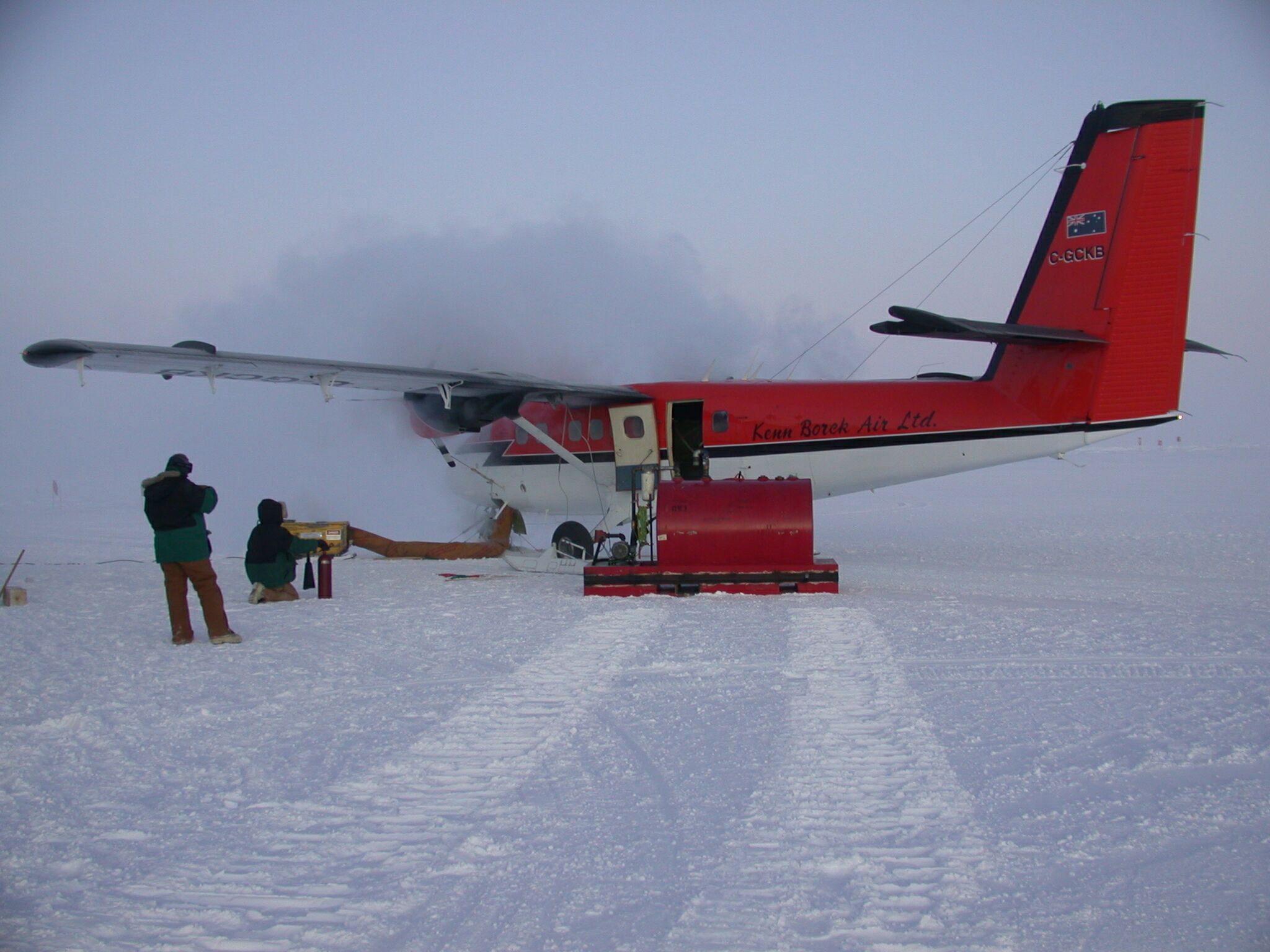 A small airplane is being fueled.